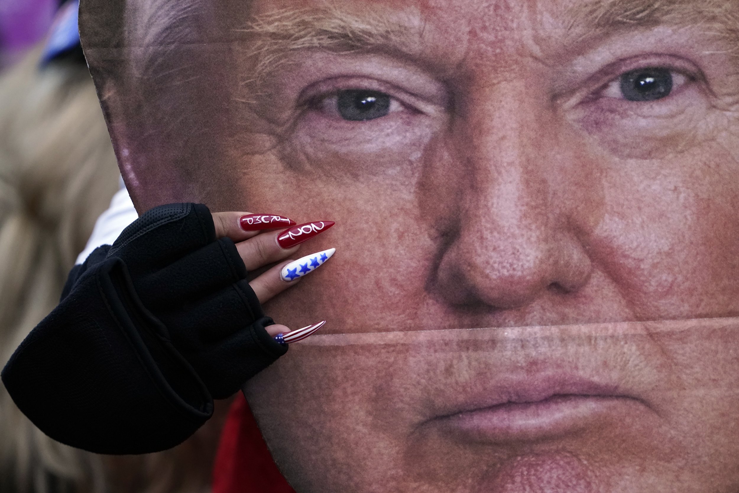  A woman holds a cutout of President Donald Trump's face at a rally in Washington in support of Trump called the "Save America Rally” on Jan. 6, 2021. (AP Photo/Jacquelyn Martin) 