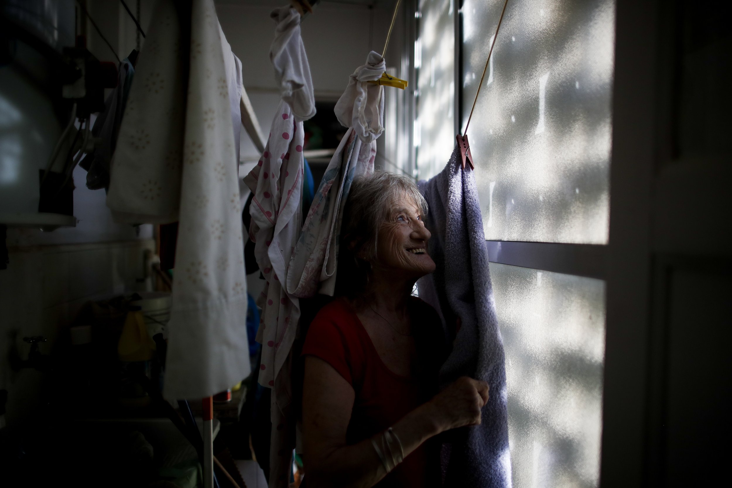  Carmela Corleto poses for a portrait amid her clothing that hangs to dry at her home in Burzaco, Argentina, where she lives alone and waits her turn to get a COVID-19 vaccine, on Feb. 18, 2021. Two months later, she got her first shot of the AstraZe