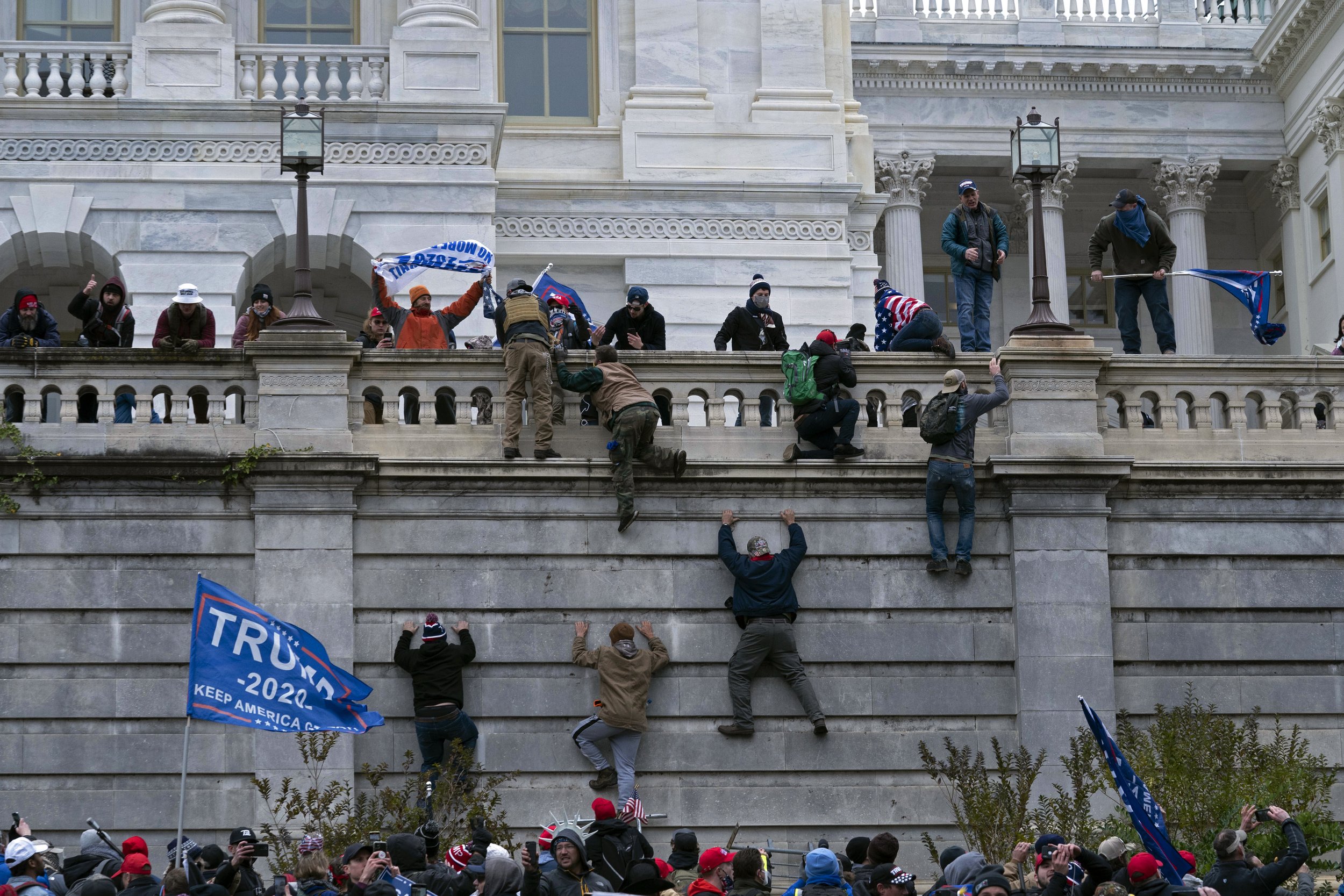  Supporters of President Donald Trump climb the west wall of the the U.S. Capitol in Washington as they try to storm the building on Jan. 6, 2021, while inside Congress prepared to affirm President-elect Joe Biden's election victory. (AP Photo/Jose L