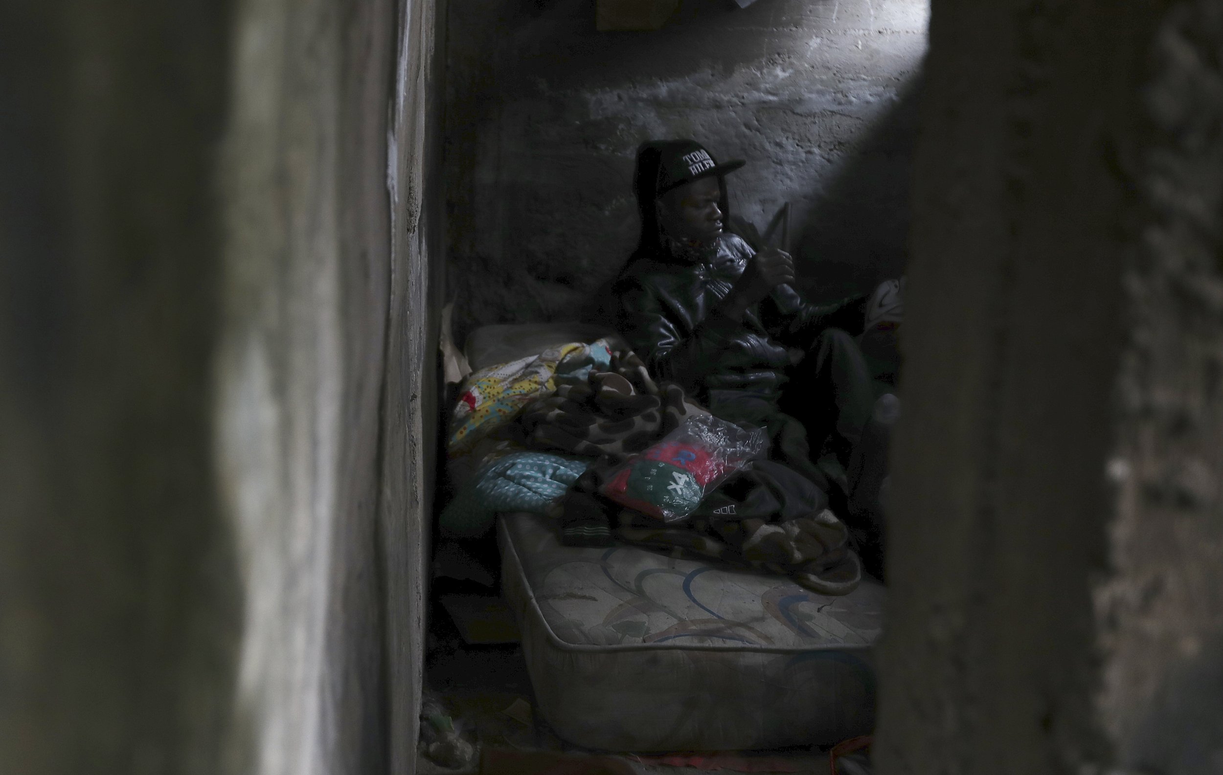  A homeless person sits inside an abandoned building in Quito, Ecuador, on March 18, 2021, during the coronavirus pandemic. (AP Photo/Dolores Ochoa) 