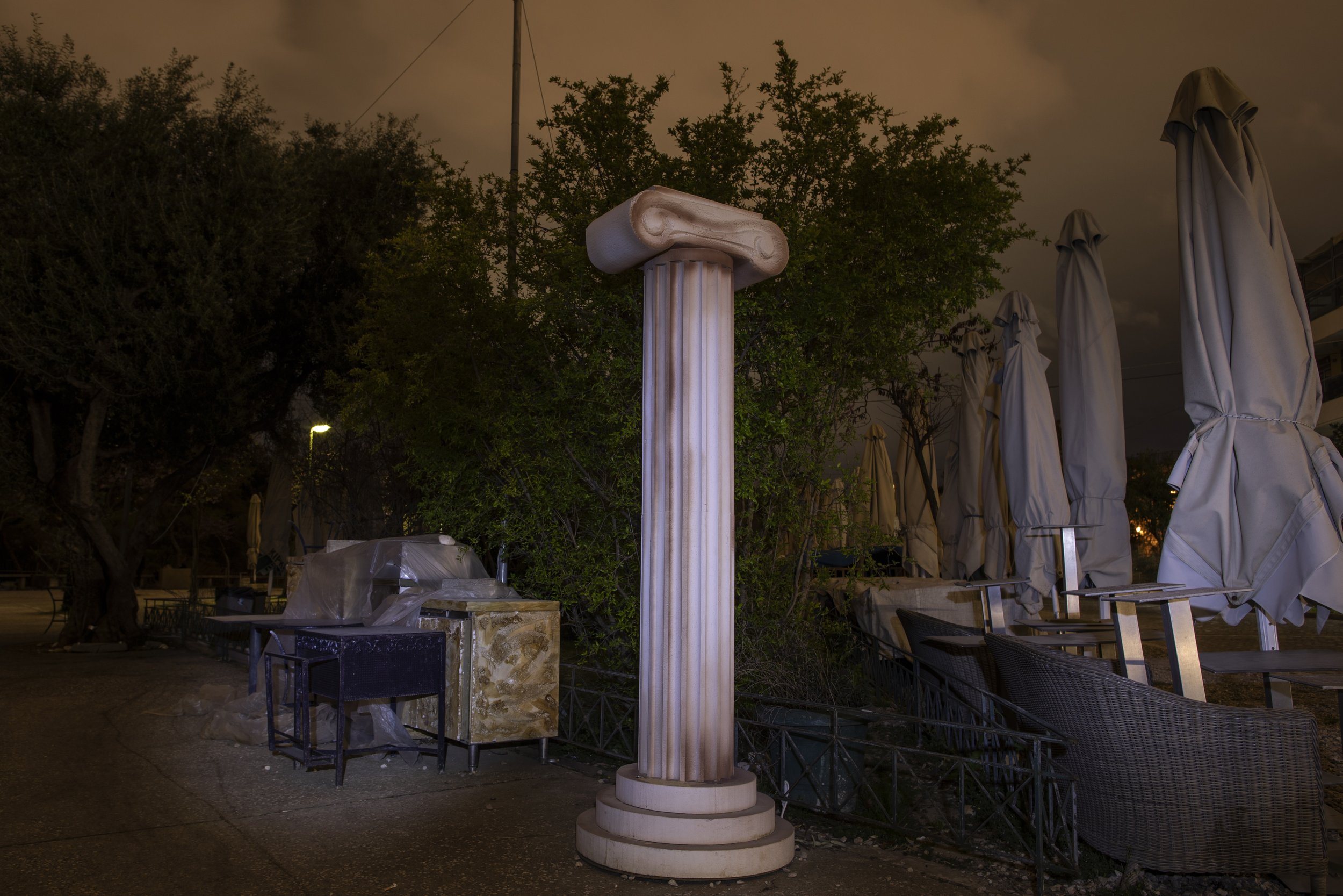  A replica of an ancient Greek column stands next to stored tables and umbrellas on March 18, 2021, outside a shuttered coffee shop in Athens, where restaurants, bars and cafes had been closed since November 2020 to curb the spread of COVID-19. (AP P