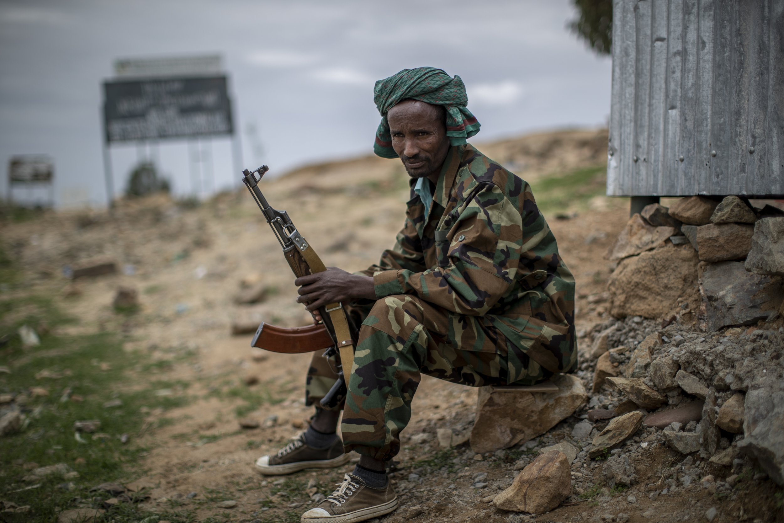  A fighter loyal to the Tigray People's Liberation Front (TPLF) mans a guard post on the outskirts of the town of Hawzen, then-controlled by the group but later re-taken by government forces, in the Tigray region of northern Ethiopia on May 7, 2021. 
