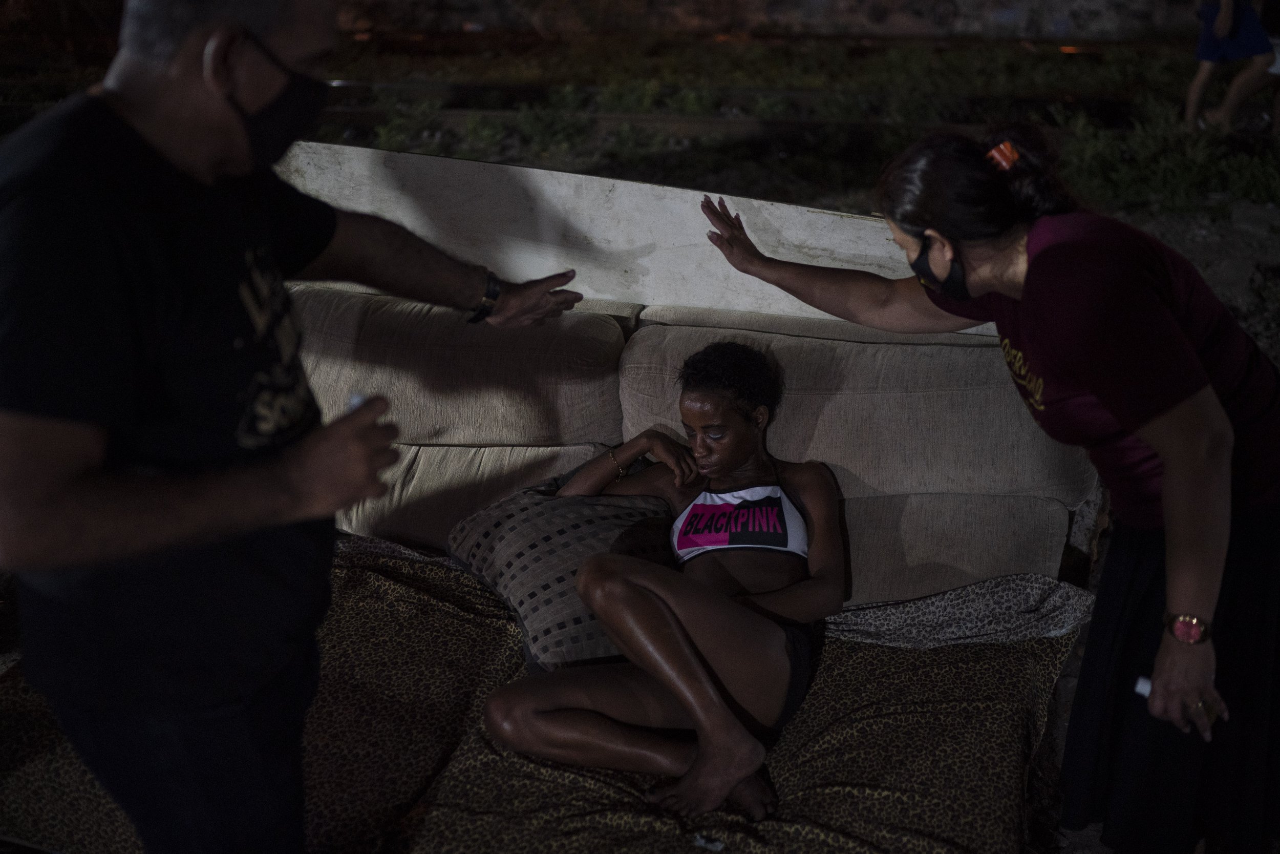  Members of the God's Love Evangelical Church and Rehab Center pray for a drug addict in an area known as “cracolandia” or crackland, in Rio de Janeiro, Brazil, on March 19, 2021. (AP Photo/Felipe Dana) 