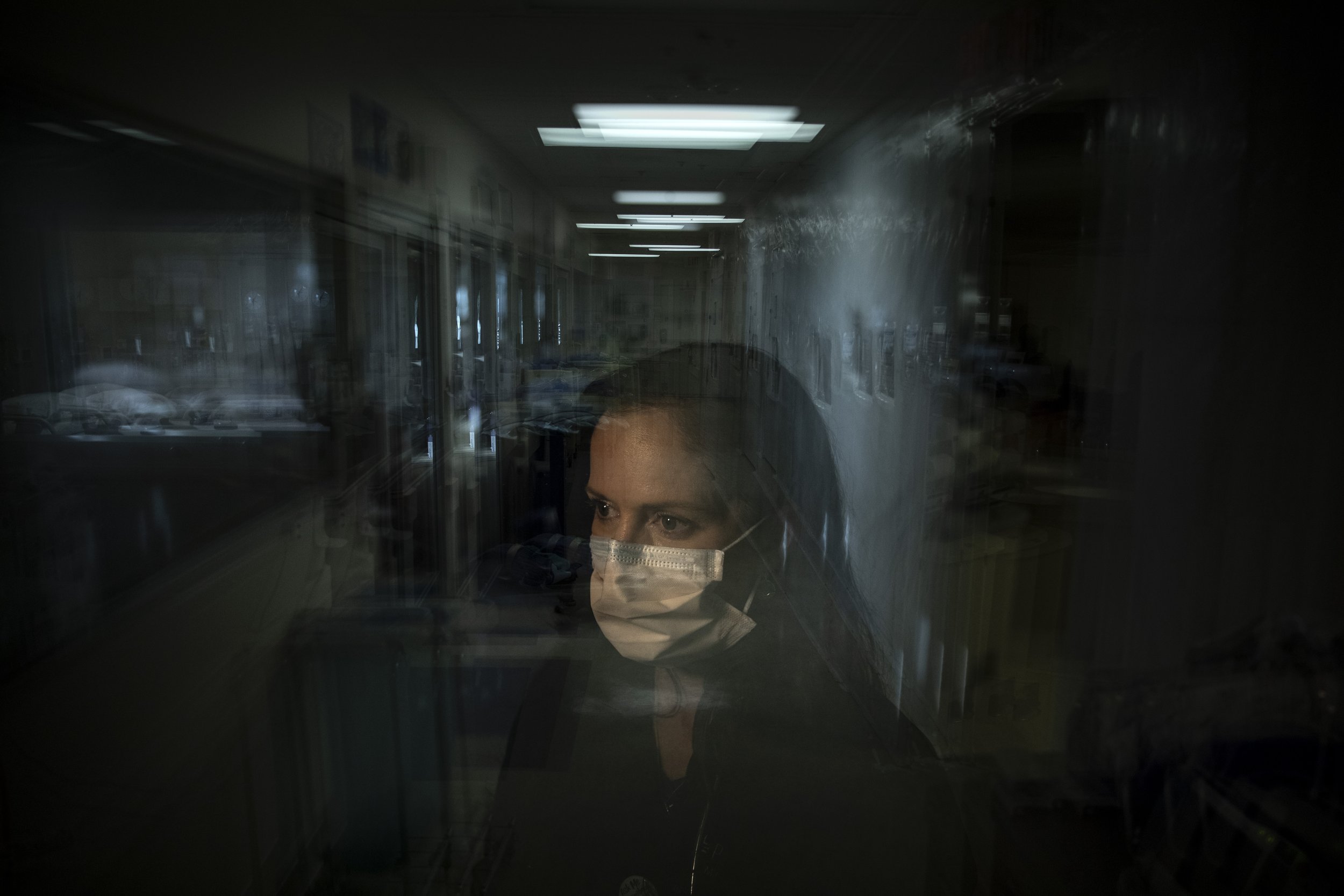  In this photo created with an in-camera multiple exposure, registered nurse Lisa Lampkin, part of the first group of nurses who had been treating coronavirus patients in an intensive care unit, stands for a photo in the empty COVID-19 ICU at Provide