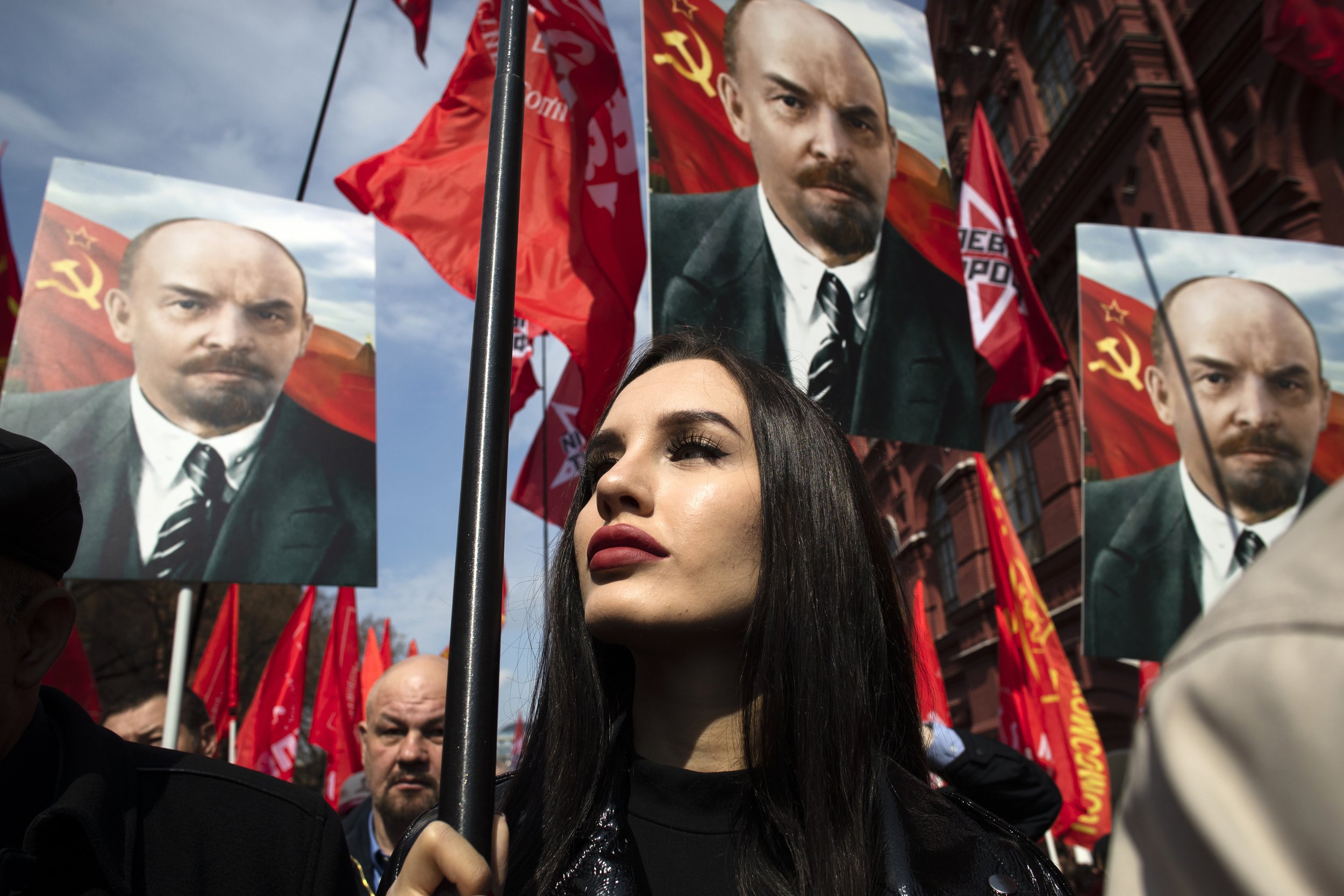  Russian communist supporters hold flags and portraits of Vladimir Lenin as they walk to the mausoleum housing the Soviet founder’s remains to mark the 151st anniversary of his birth on April 22, 2021, in Moscow. (AP Photo/Pavel Golovkin) 