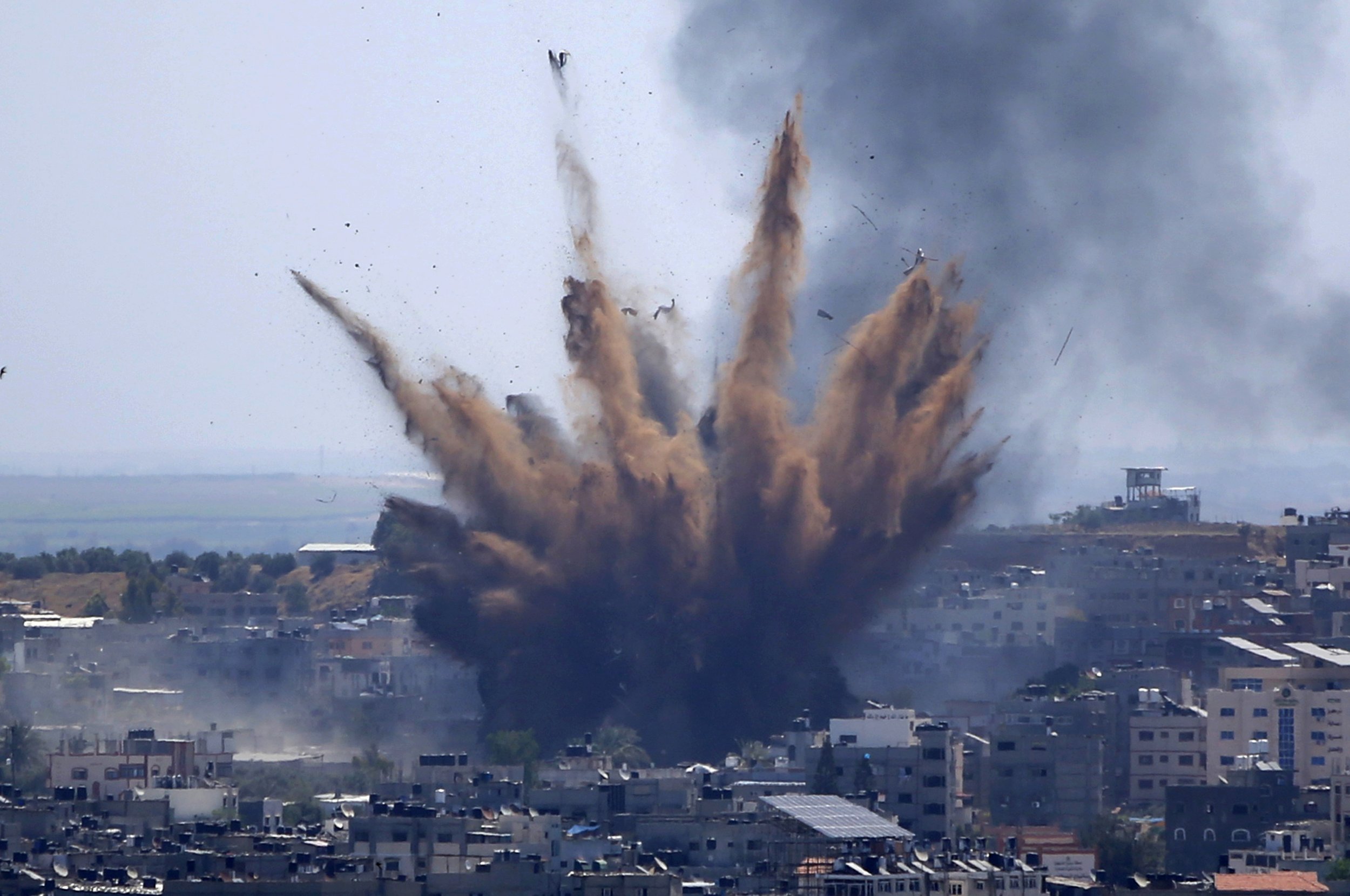  A blast from an Israeli airstrike on a building in Gaza City throws dust and debris on May 13, 2021, as Hamas and Israel traded more rockets and airstrikes and Jewish-Arab violence raged across Israel at the end of the Muslim holy month of Ramadan. 