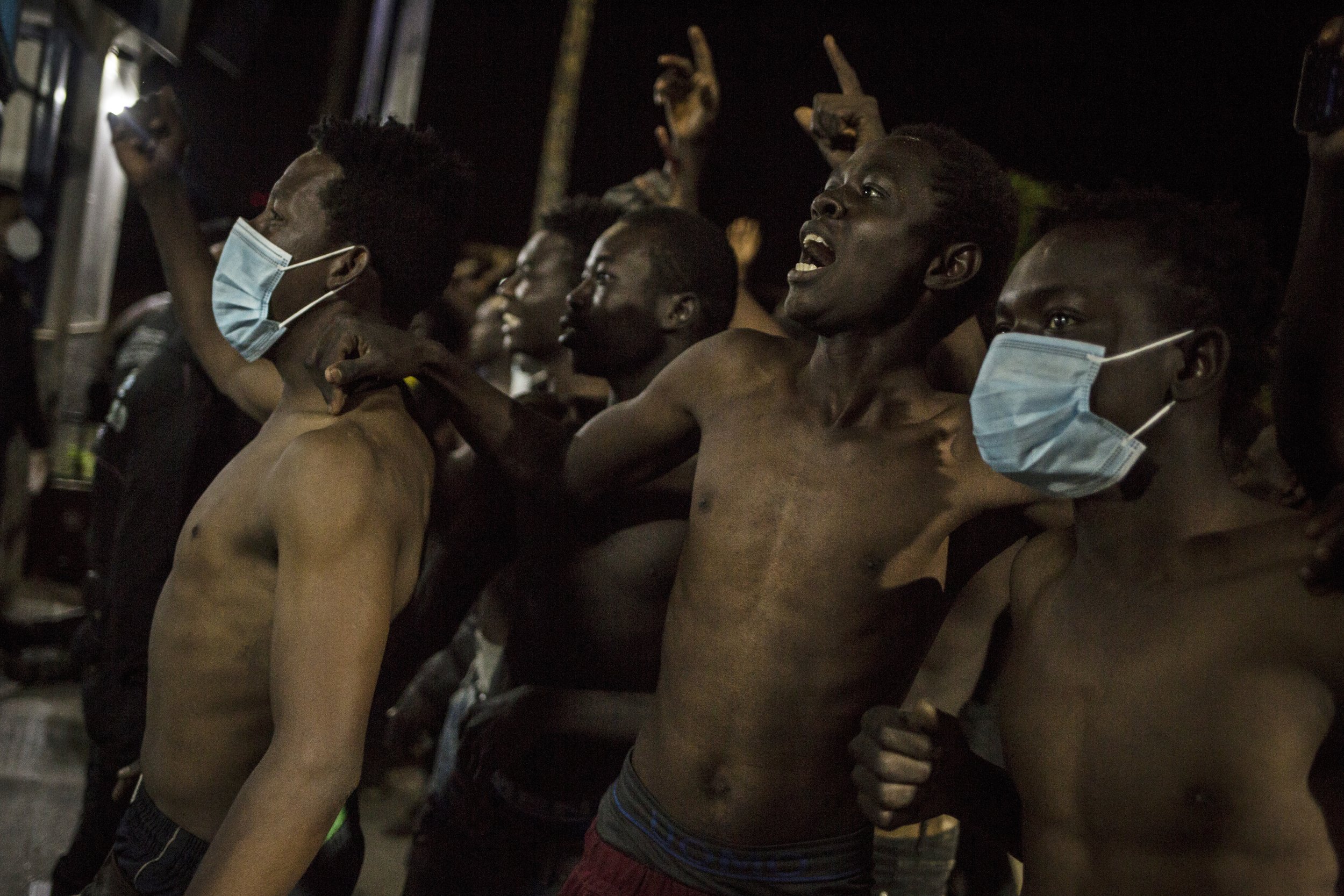  A group of migrants arrive outside a holding center for migrants in the Spanish North African enclave of Melilla, on May 18, 2021, after crossing into Melilla in the early hours by jumping over the enclave's double fence. (AP Photo/Javier Bernardo) 