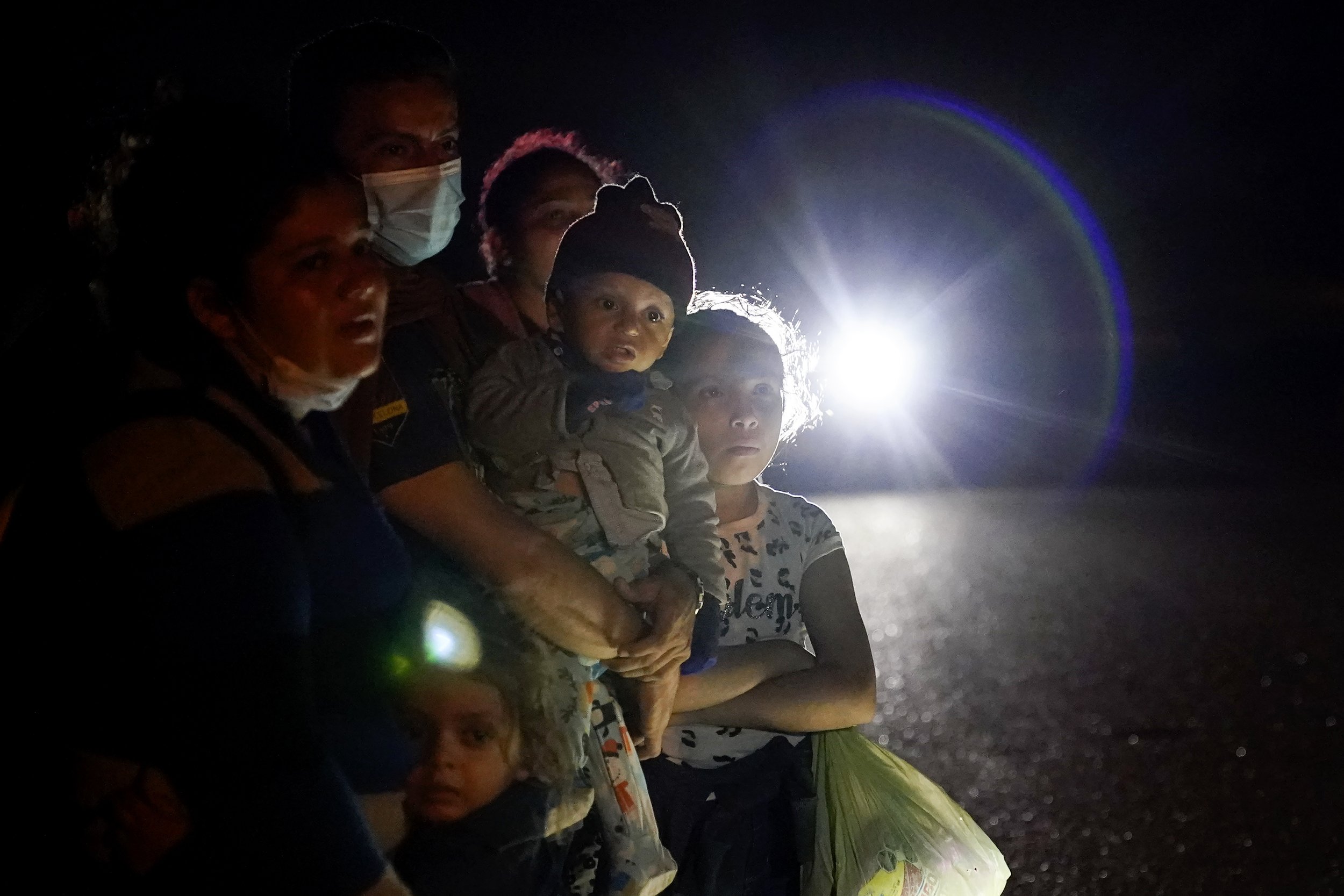  A group of migrants mainly from Honduras and Nicaragua wait along a road after turning themselves in upon crossing the U.S.-Mexico border, in La Joya, Texas, on May 17, 2021. (AP Photo/Gregory Bull) 