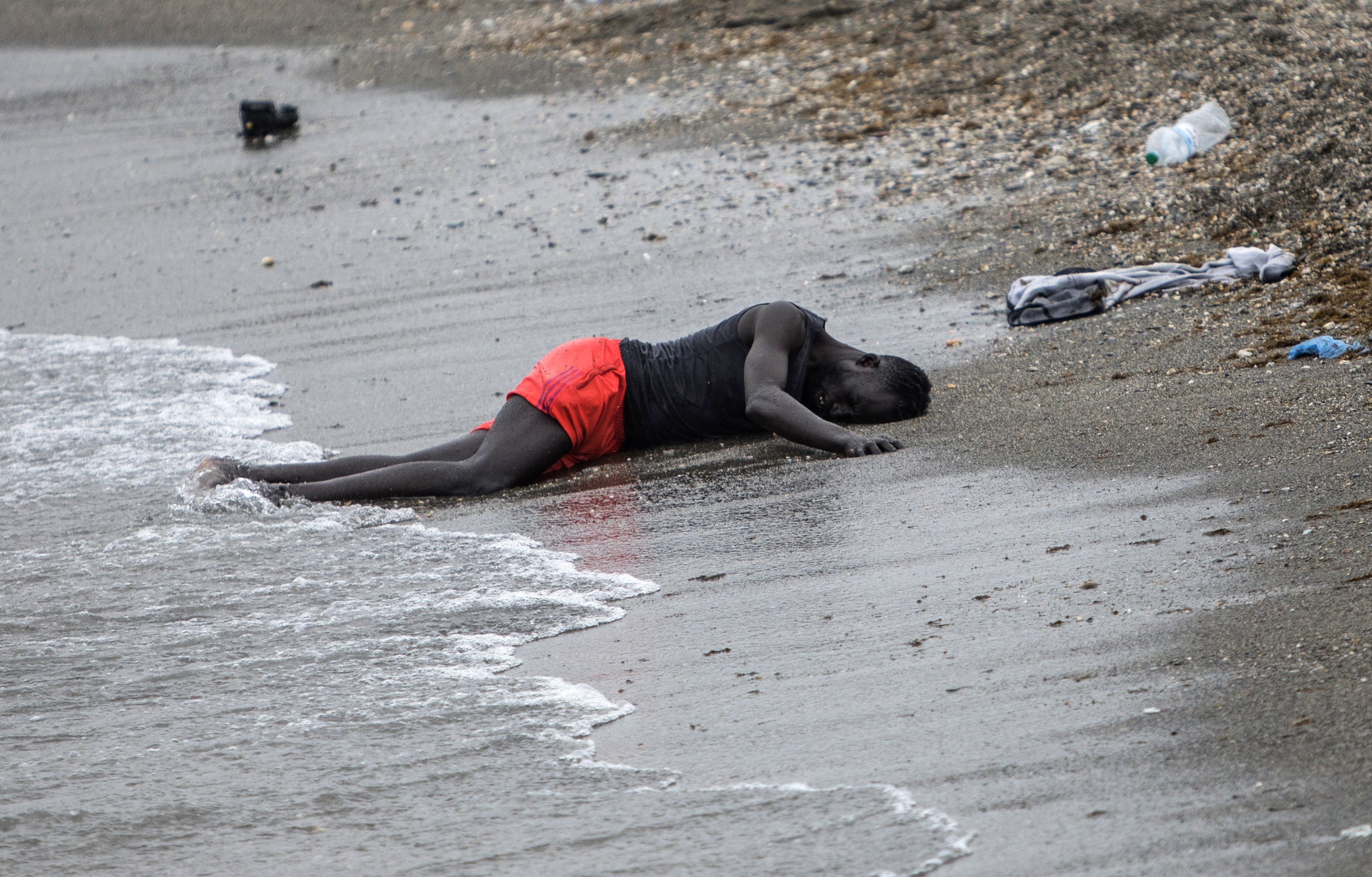  A man lies on the beach in the Spanish enclave of Ceuta in northern Africa after swimming there from Morocco on May 18, 2021. (AP Photo/Javier Fergo) 