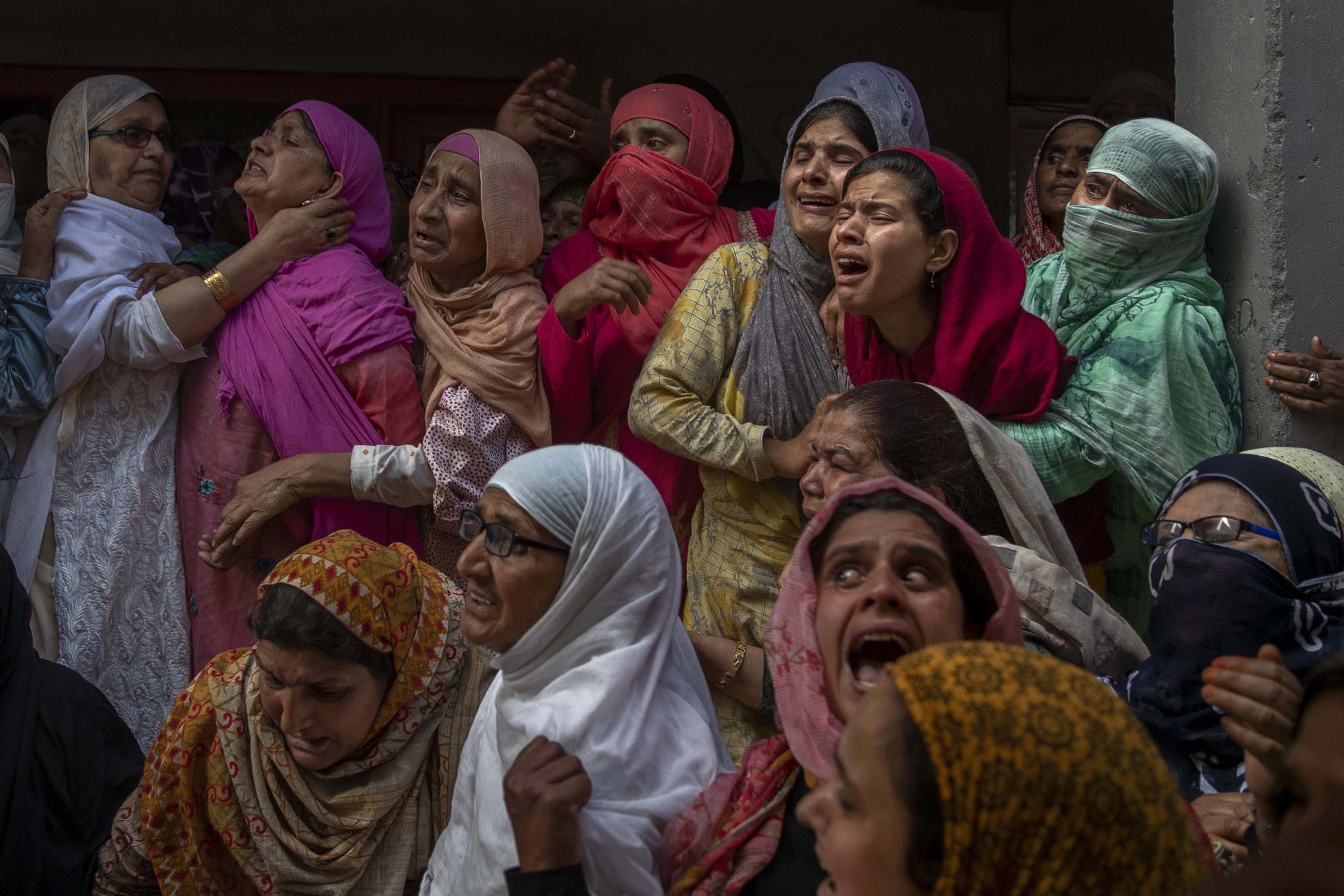  Relatives and neighbors wail during the funeral of Waseem Ahmed, a policeman who was killed in a shootout, on the outskirts of Srinagar, Indian controlled Kashmir, on June 13, 2021. (AP Photo/Dar Yasin) 