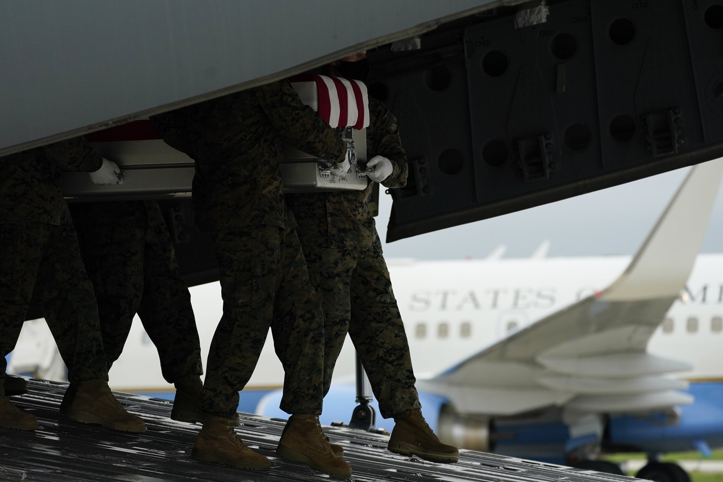  A carry team moves a transfer case containing the remains of Marine Corps Staff Sgt. Darin T. Hoover, 31, of Salt Lake City, on Aug. 29, 2021, at Dover Air Force Base, Del. According to the Department of Defense, Hoover died in an attack at Afghanis