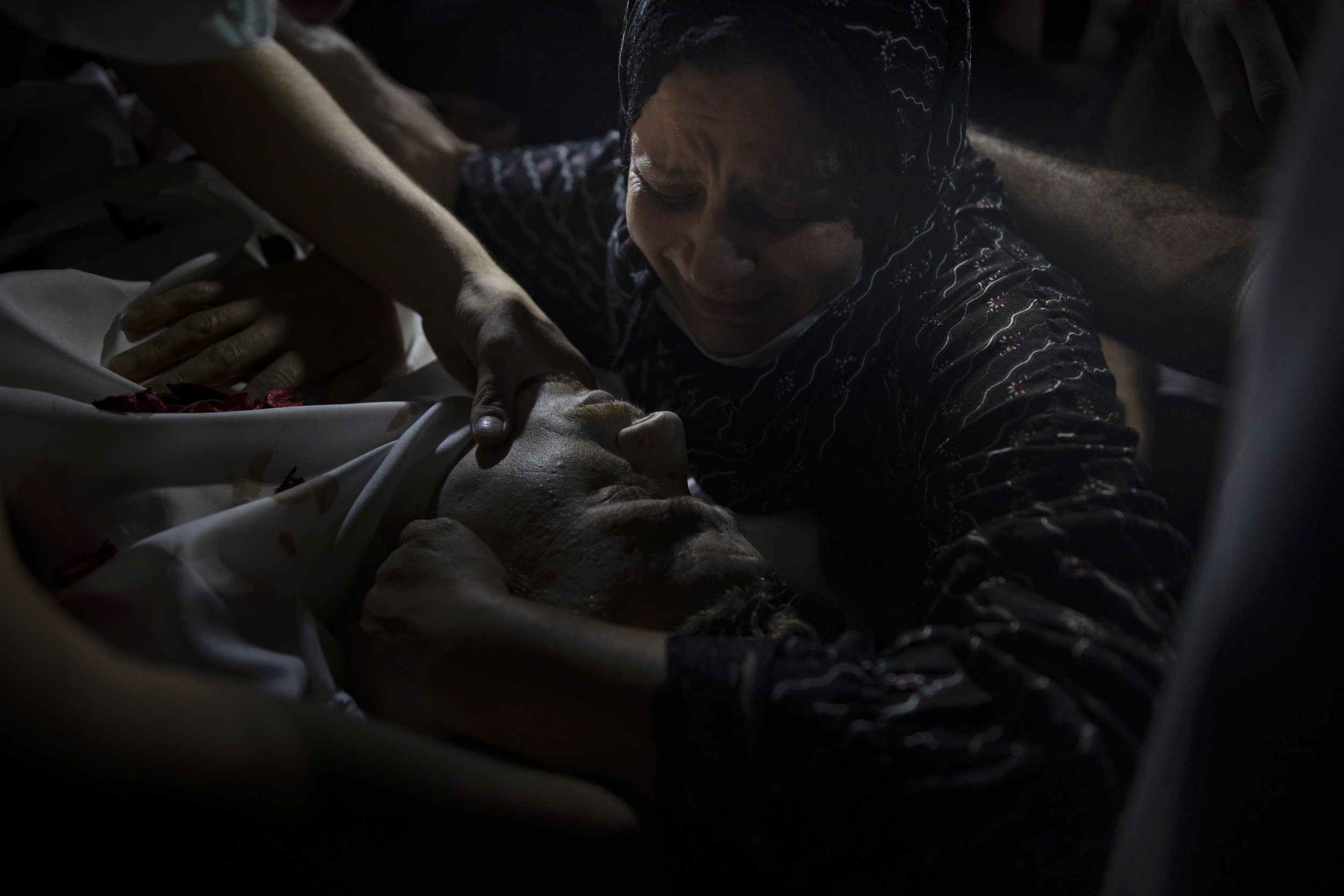  A relative of Ahmad Saleh, 26, who was killed by Israeli gunfire during a protest along the Israeli border, mourns over his body during his funeral in Jabaliya refugee camp, northern Gaza Strip, on Sept. 3, 2021. (AP Photo/Khalil Hamra) 