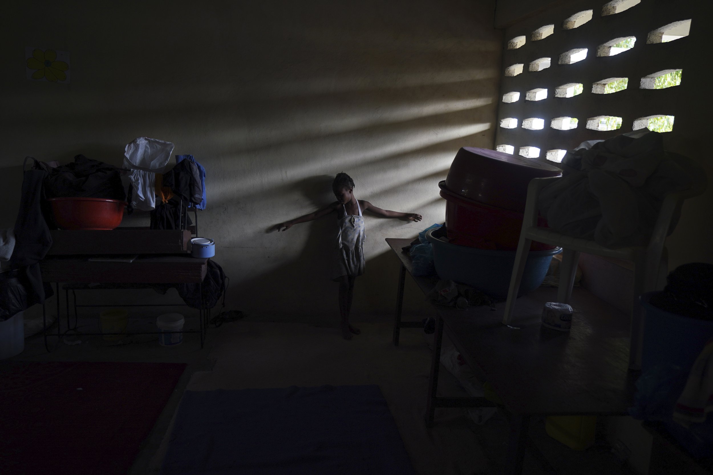  A girl plays inside a classroom where her family is staying at a school-turned-shelter for those displaced by the 7.2 magnitude earthquake in Les Cayes, Haiti, on Aug. 18, 2021. (AP Photo/Fernando Llano) 