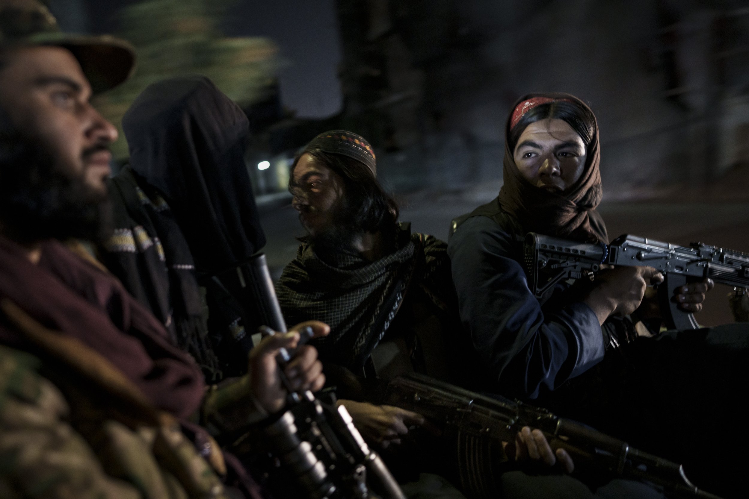  Taliban fighters ride in the back of a vehicle during a night patrol in Kabul, Afghanistan, on Sept. 12, 2021. (AP Photo/Felipe Dana) 