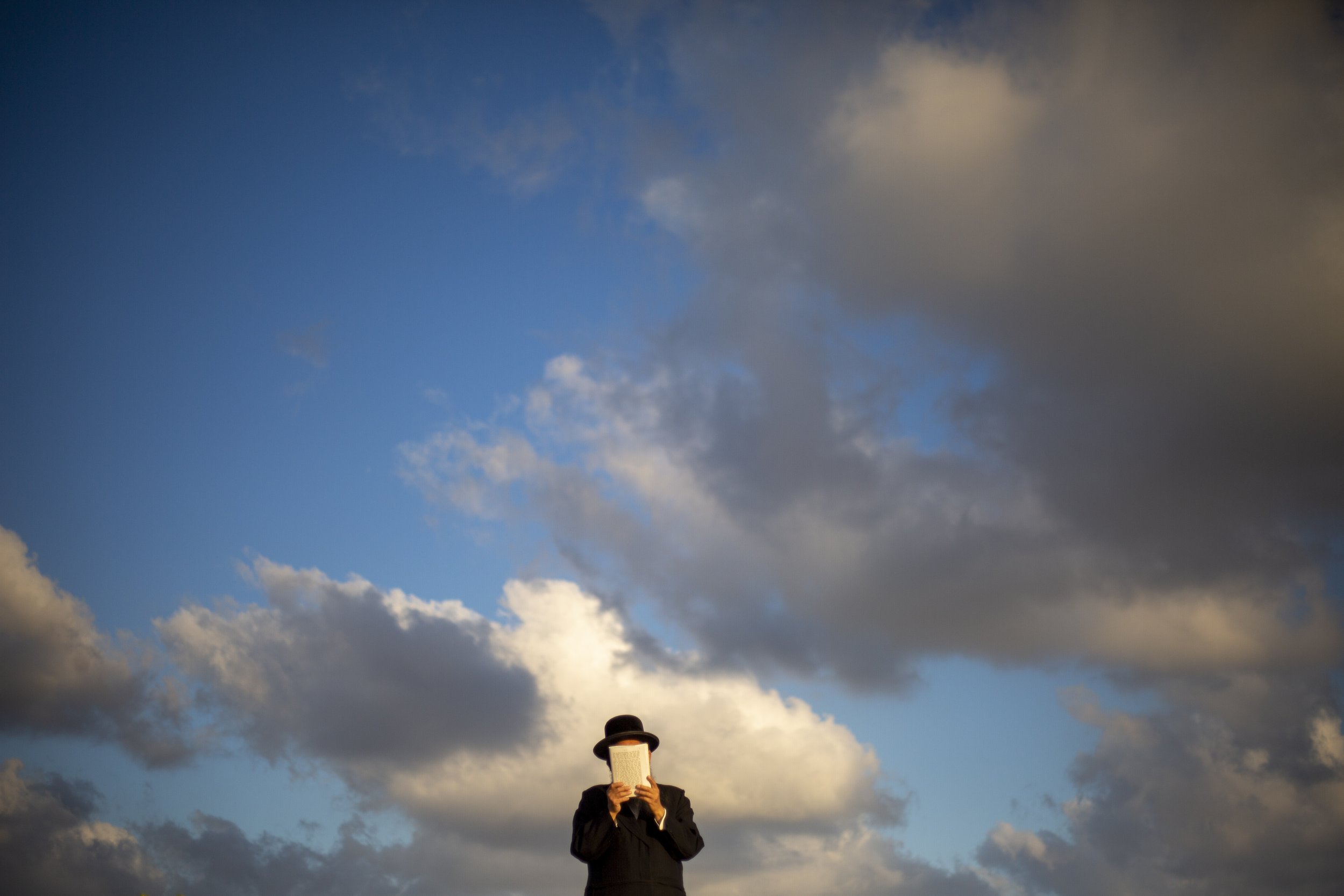  An Ultra-Orthodox Jewish man from the Kiryat Sanz Hassidic sect prays on a hill overlooking the Mediterranean Sea during a Tashlich ceremony in Netanya, Israel, on Sept. 14, 2021. Tashlich, which means "to cast away" in Hebrew, is the practice in wh