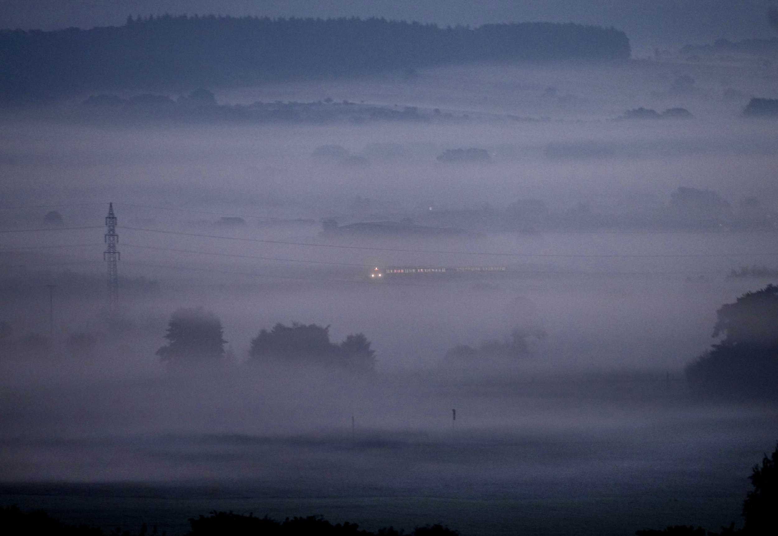  A train travels through thick fog in the Taunus region of Germany near Frankfurt, on Sept. 17, 2021. (AP Photo/Michael Probst) 