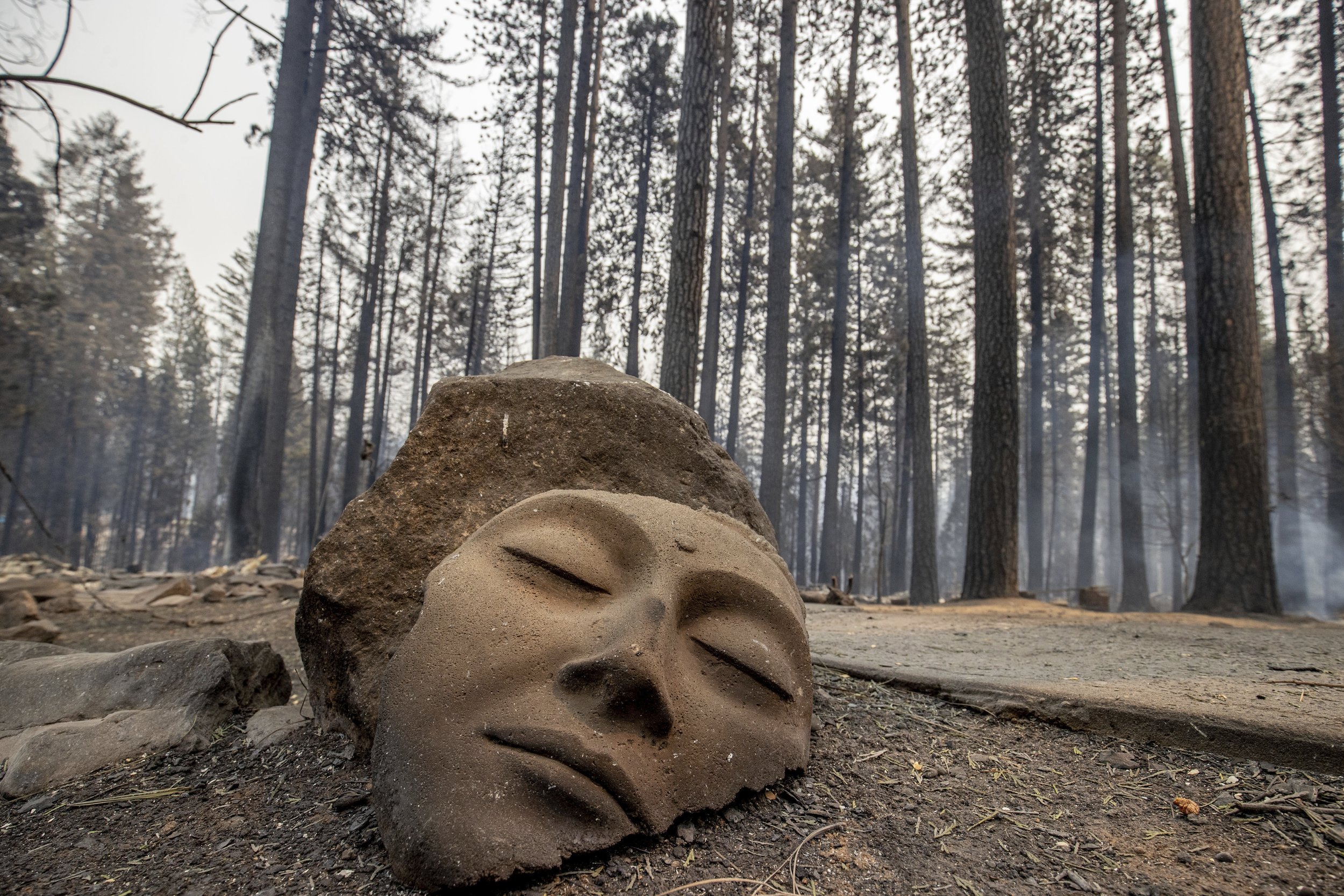  A sculpture rests in front of a Grizzly Flats home destroyed by the Caldor Fire in El Dorado County, Calif., on Aug. 17, 2021. (AP Photo/Ethan Swope) 