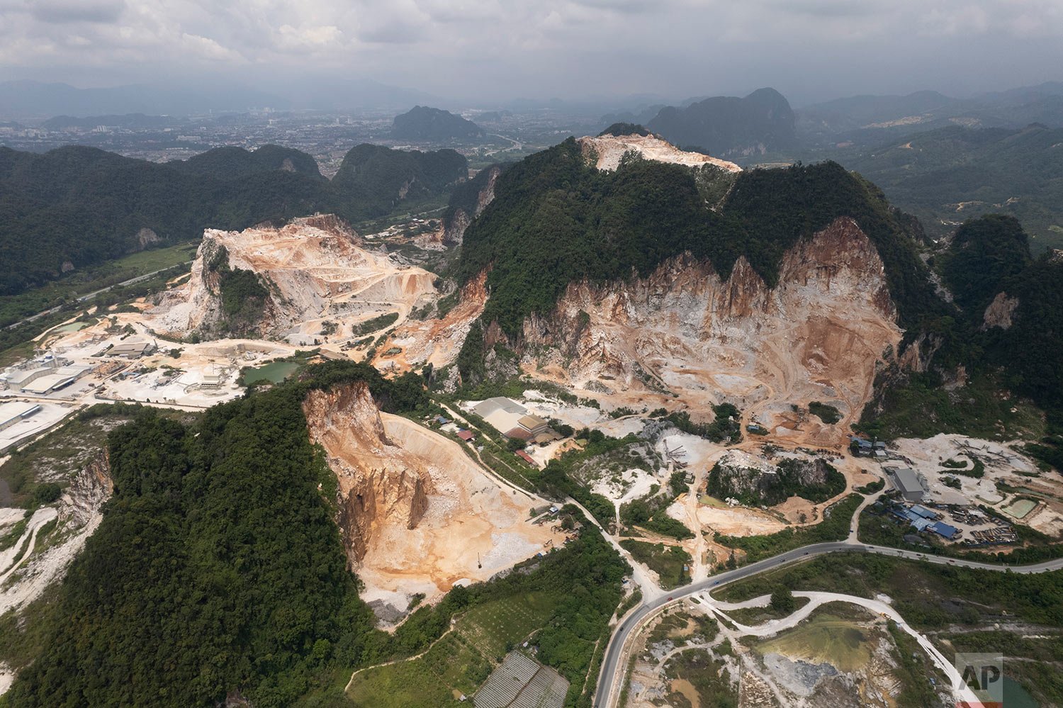  Deforested mountains from massive limestone quarries are seen in Ipoh, Perak state Malaysia, Friday, Nov. 5, 2021.  (AP Photo/Vincent Thian) 