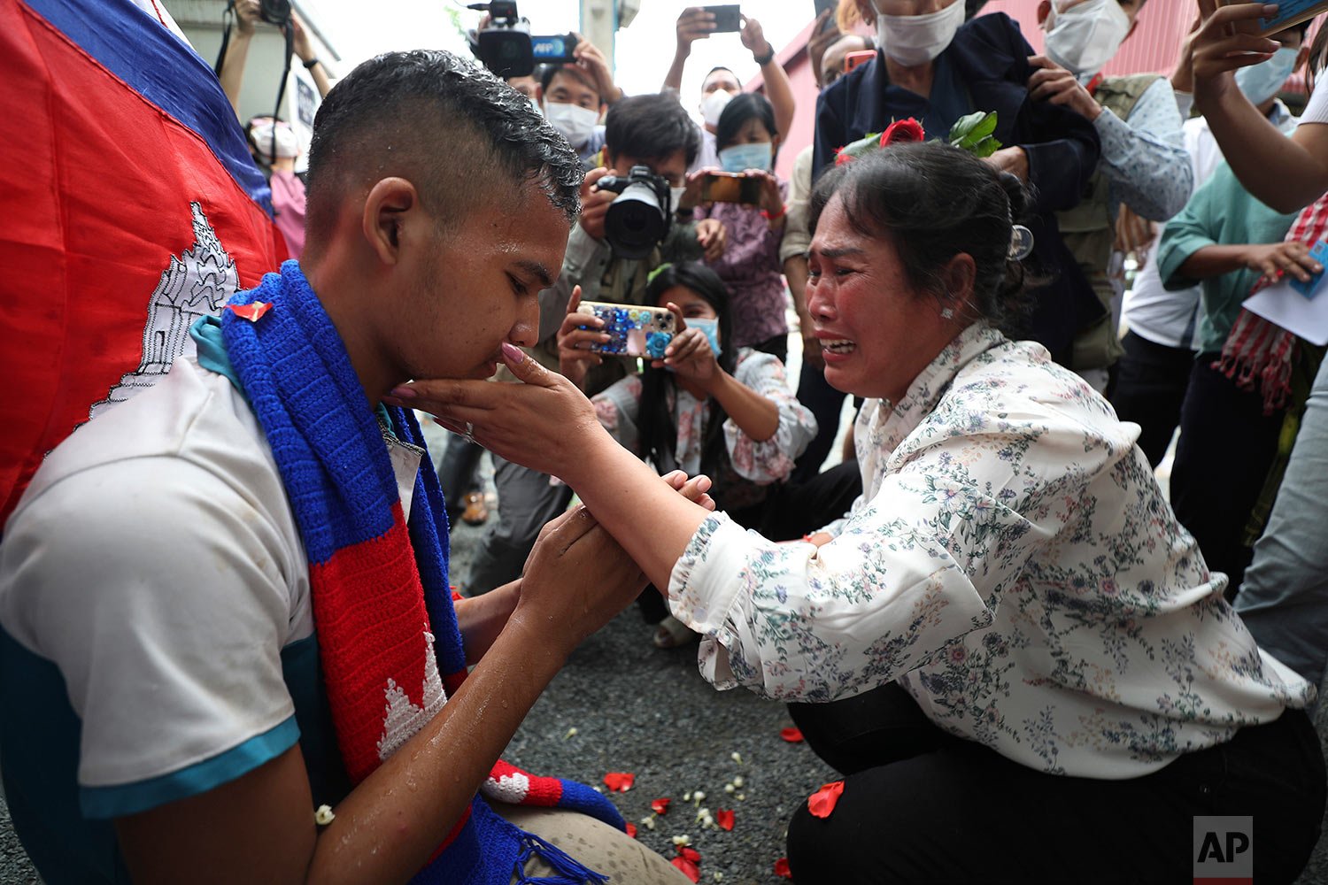  Prum Chantha, right, meets her son Kak Sovannchhay, 16, outside the main prison of Prey Sar after the autistic teenager was released after serving time for posting comments critical of the government on social media, in a case that has attracted glo
