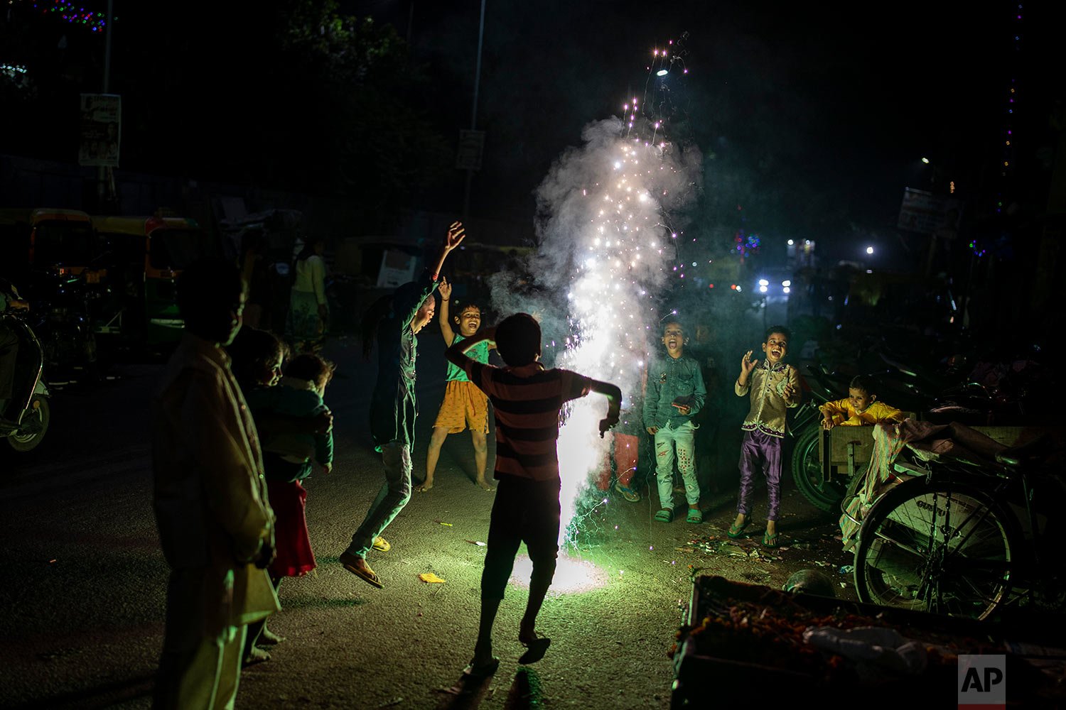  Children play with firecrackers during Diwali celebrations in New Delhi, India, Thursday, Nov. 4, 2021.  (AP Photo/Altaf Qadri) 