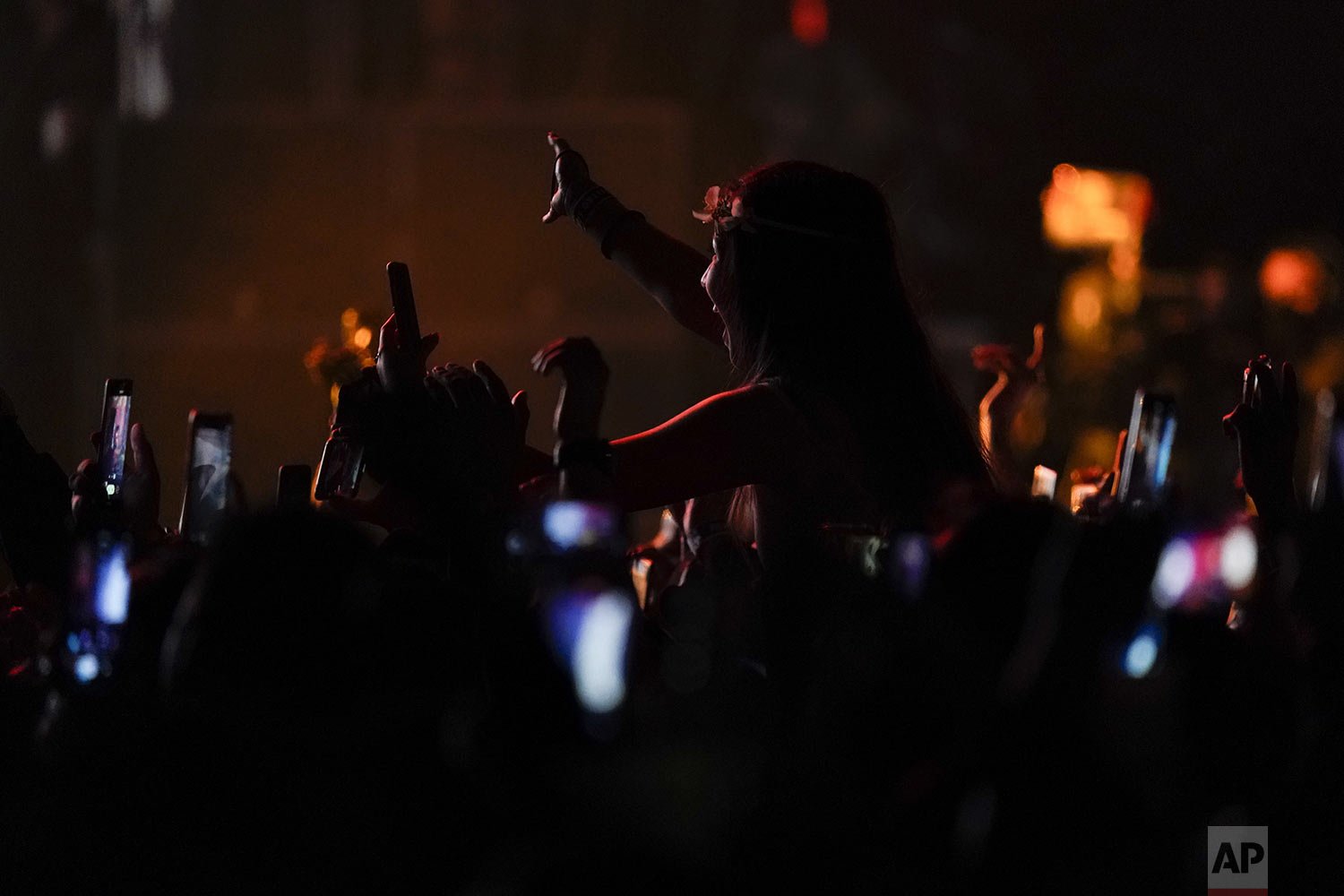  Fans takes pictures of American singer Laura Pergolizzi, aka as LP,  as she performs at the Corona Capital music festival in Mexico City, Nov. 20, 2021.  (AP Photo/Eduardo Verdugo) 