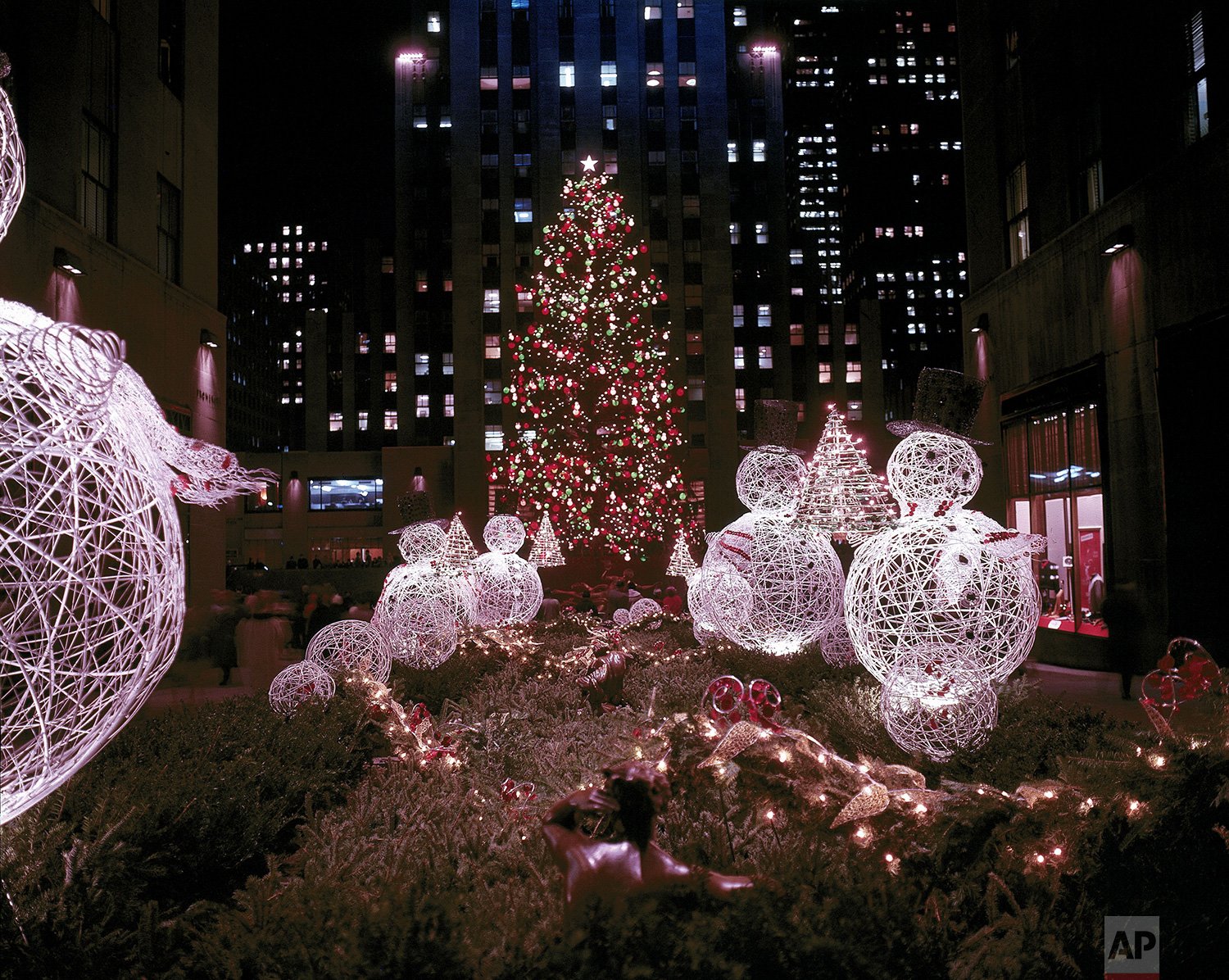  This is a night view of the famous Christmas tree at Rockefeller Center, seen through the Channel Gardens from Fifth Avenue, in December 1961.  (AP Photo) 