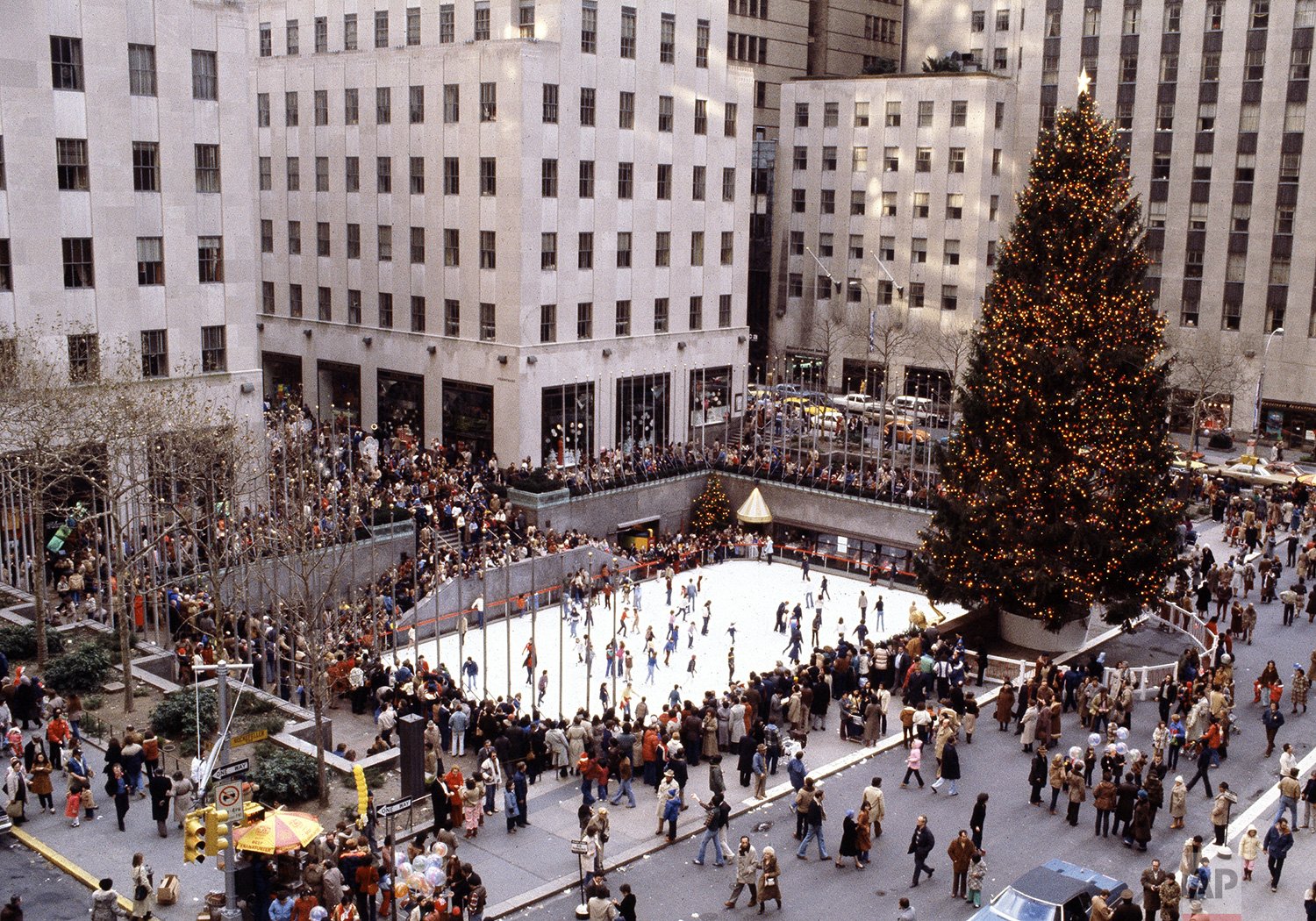  The Christmas tree towers over the ice skating rink at Rockefeller Center in New York City on Christmas Day, Dec. 25, 1979. (AP Photo/Marty Lederhandler) 