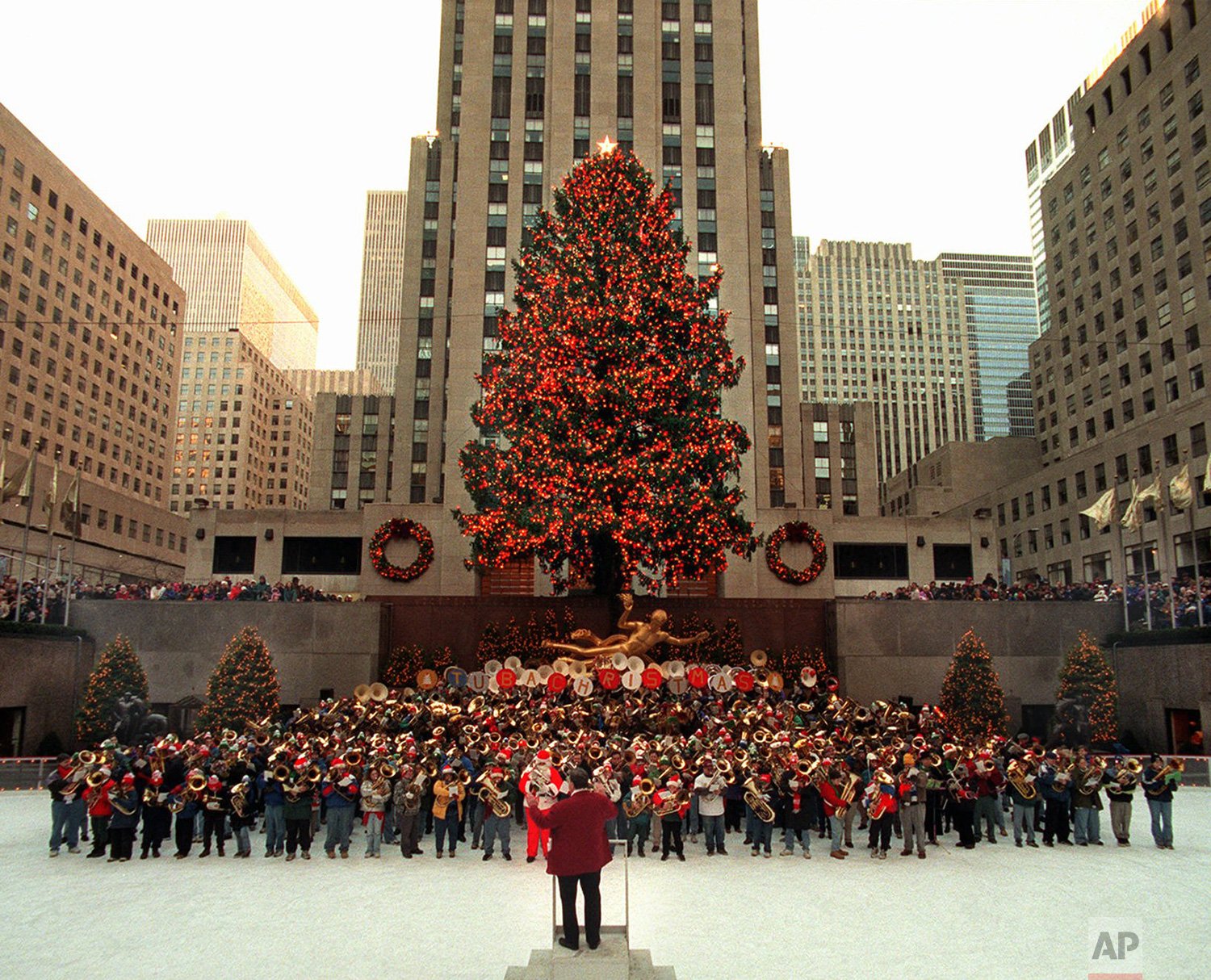  Some of the more than 500 tuba players participating in the 24th Annual Tuba Christmas play during a concert on the ice at Rockefeller Center's skating rink below a 74-foot Norway spruce  Sunday, Dec. 14, 1997, in New York. (AP Photo/Adam Nadel) 