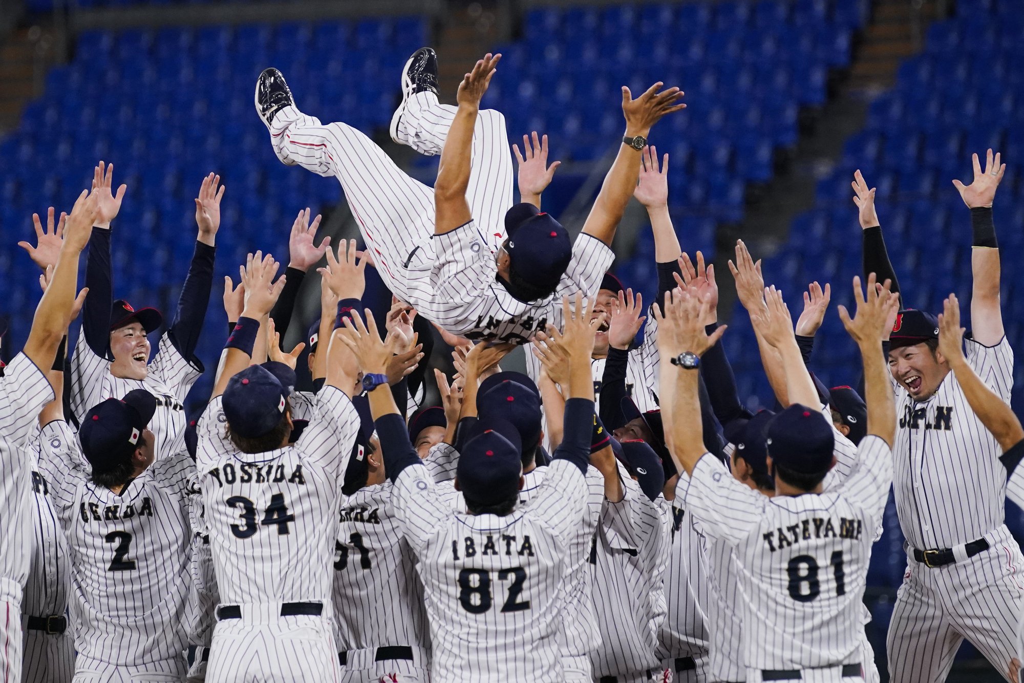  Team Japan celebrate with their manager Atsunori Inaba after the gold medal baseball game against the United States at the 2020 Summer Olympics, Saturday, Aug. 7, 2021, in Yokohama, Japan. Japan won 2-0. (AP Photo/Sue Ogrocki) 