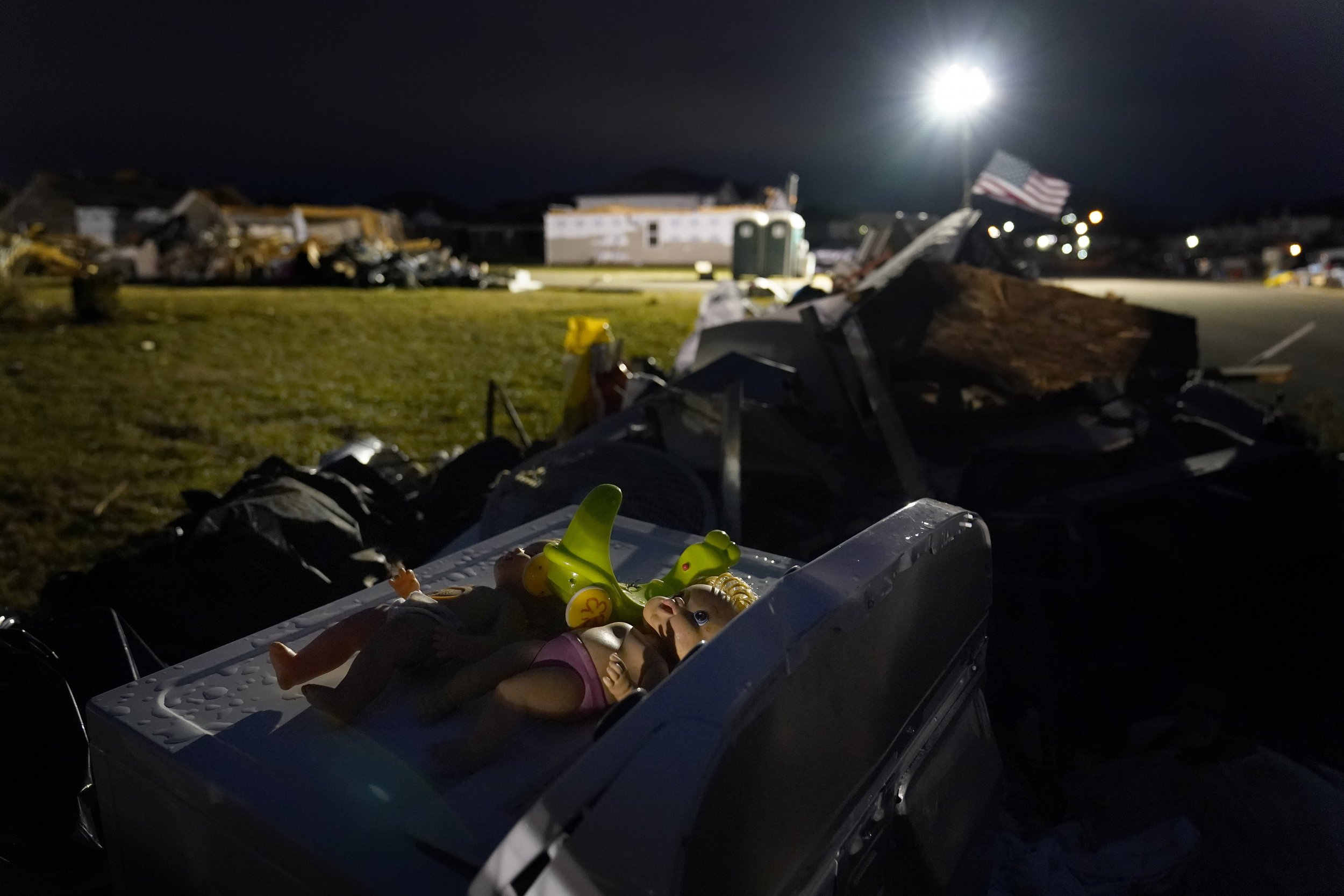  Toys set by someone on top of a washing machine lie outside surrounded by debris after an early rain on Sunday, Dec. 19, 2021, in Bowling Green, Ky. (AP Photo/Brynn Anderson) 