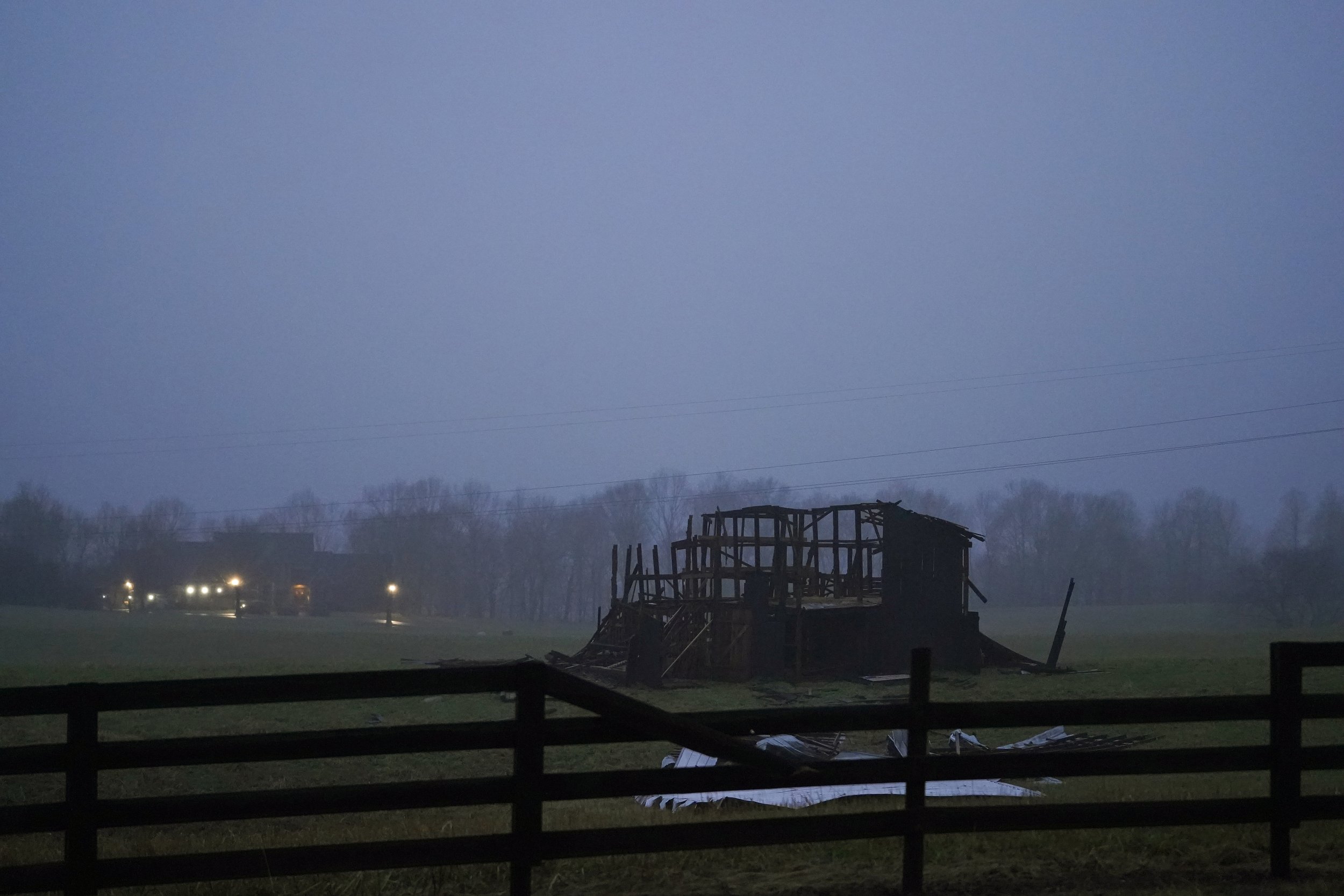  A barn destroyed by a tornado stands in a field near a house that escaped the worst of the storm on Porter Pike road in Bowling Green, Ky., Dec. 18, 2021.  (AP Photo/Brynn Anderson) 