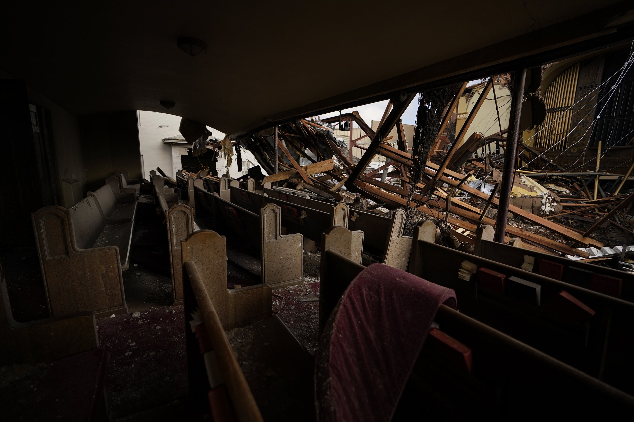  The roof is collapsed between the pews and the organ pipes in the First United Methodist church in Mayfield, Ky., on Dec. 19, 2021. (AP Photo/Brynn Anderson) 