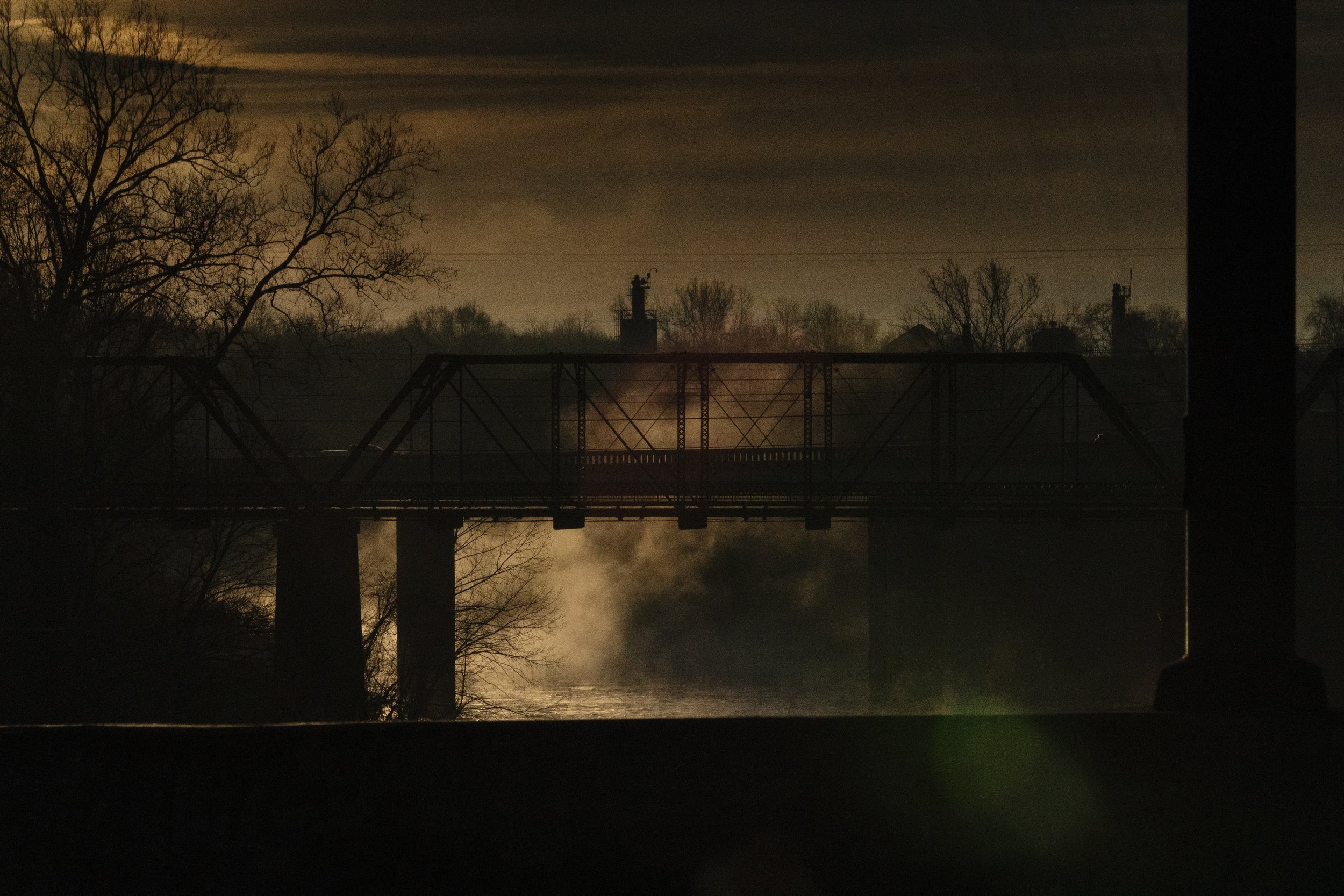  Morning fog rises over a walking bridge in Bowling Green, Ky., on Dec. 20, 2021. (AP Photo/Brynn Anderson) 
