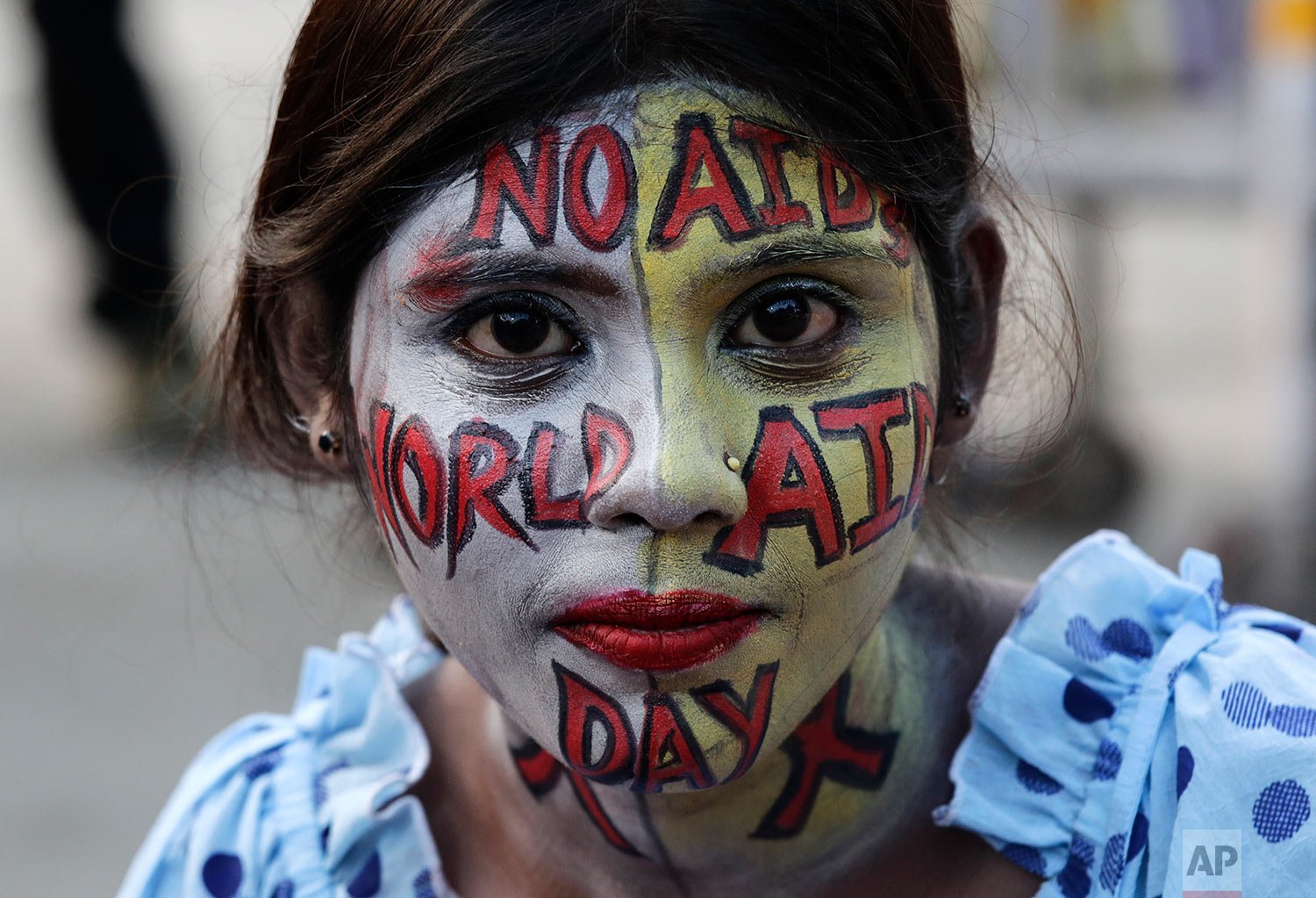  A girl,  with her face painted, participates in an HIV and AIDS awareness program on World AIDS Day in Kolkata, India, Wednesday, Dec. 1, 2021. (AP Photo/Bikas Das) 