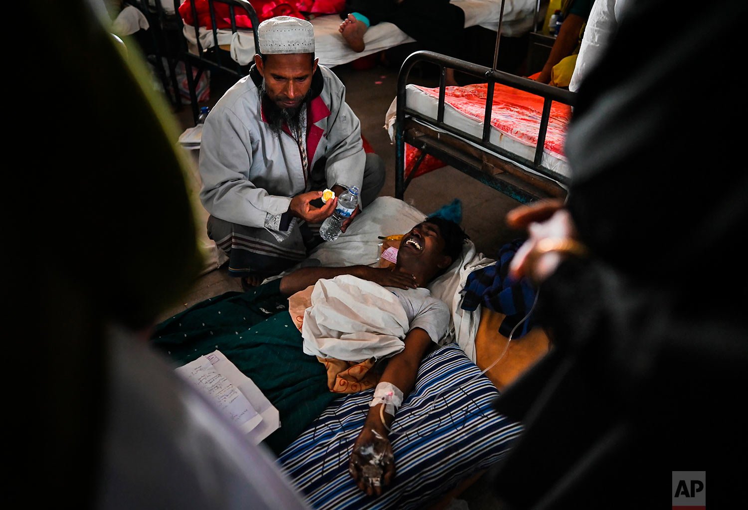  An injured survivor of a ferry fire cries in a pain as he receives treatment at a government medical hospital, in Barishal, Bangladesh, Friday, Dec. 24, 2021.  (AP Photo/Niamul Rifat) 