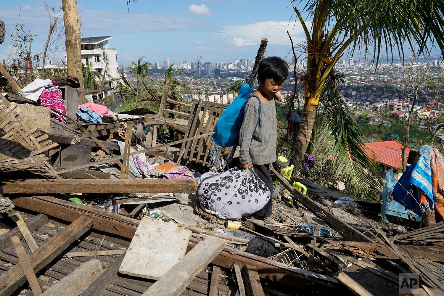  Romel Lo-ang recovers personal belongings from their damaged home due to Typhoon Rai in Cebu province, central Philippines on Sunday Dec. 19, 2021. (AP Photo/Jay Labra) 
