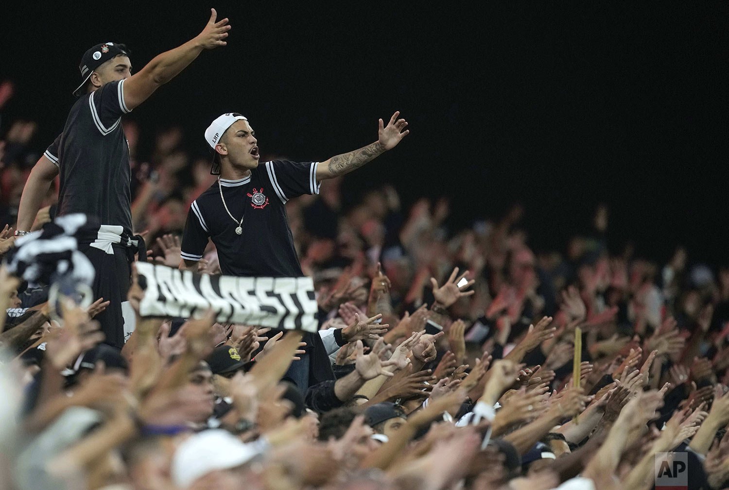  Corinthians soccer fans cheer during a women's championship  soccer final match against Sao Paulo in Sao Paulo, Brazil, Dec. 8, 2021. (AP Photo/Andre Penner) 