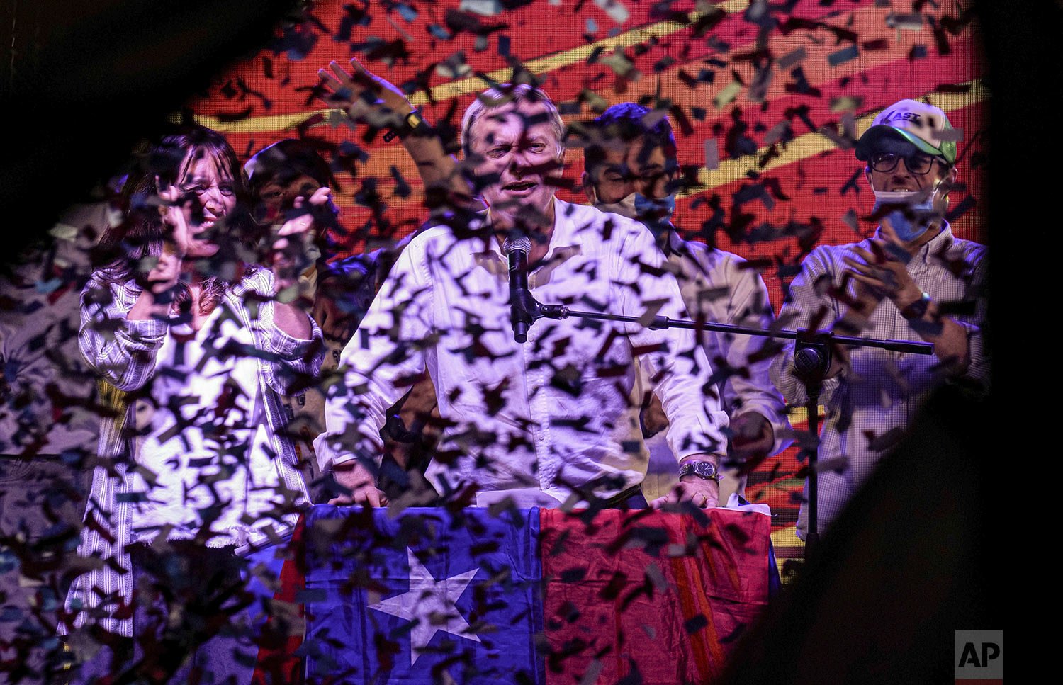  Showered by confetti, Republican Party presidential candidate Jose Antonio Kast stands next to his wife Maria Pia Adriasola at his closing campaign rally ahead of the presidential run-off election in Santiago, Chile, Dec. 16, 2021. (AP Photo/Esteban