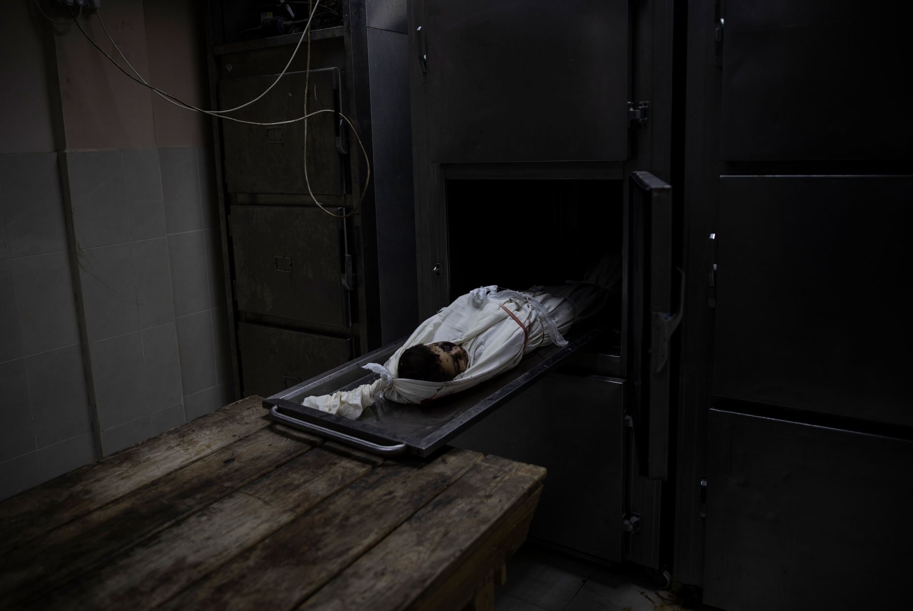  The body of 11-year-old Dima Assaliya, covered with a white cloth, lies in a morgue after she was killed by an Israeli airstrike in town of Jabaliya, northern Gaza Strip, Thursday, May 20, 2021. (AP Photo/Khalil Hamra) 