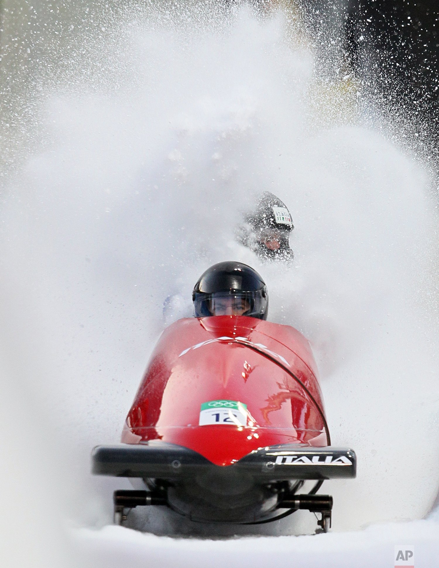  Italy's ITA-1, piloted by Simone Bertazzo with brakeman Samuele Romanini, brakes in the finish area during the men's two-man bobsled competition at the Vancouver 2010 Olympics in Whistler, British Columbia, on Feb. 20, 2010. (AP Photo/Ricardo Mazala