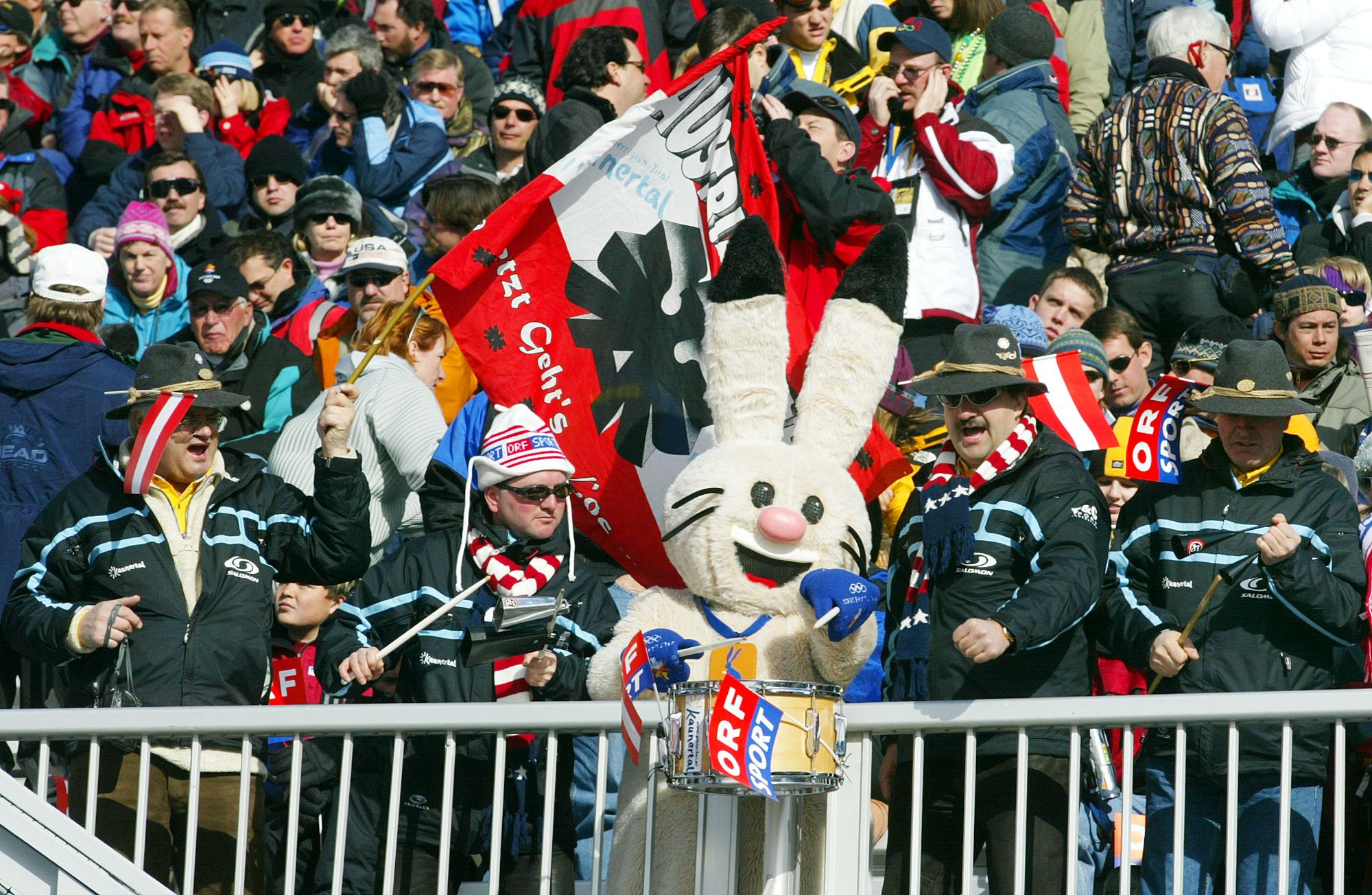  Supporters of the Austrian ski team make music with Powder one of the Salt Lake City Winter Olympic Games mascots as they wait for the start of the weather delayed women's downhill in Snowbasin, Utah on Feb. 11, 2002. (AP Photo/Rudi Blaha) 