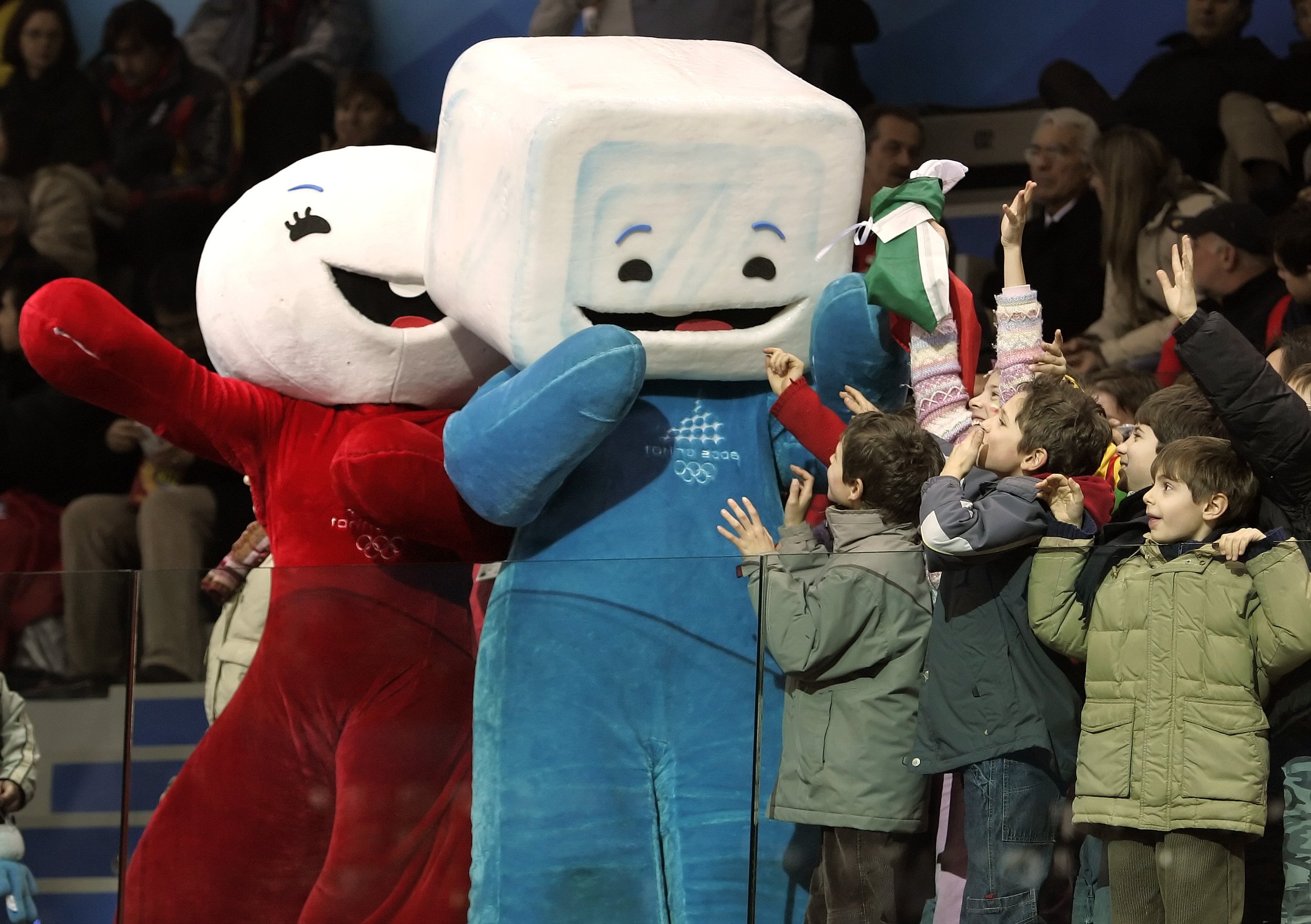  Children attending the short track skating races in the Palavela Arena cheer with Torino Olympic mascots Neve, left and Gliz at the 2006 Winter Olympics in Turin, Italy, Feb. 15, 2006.  (AP Photo/Amy Sancetta) 
