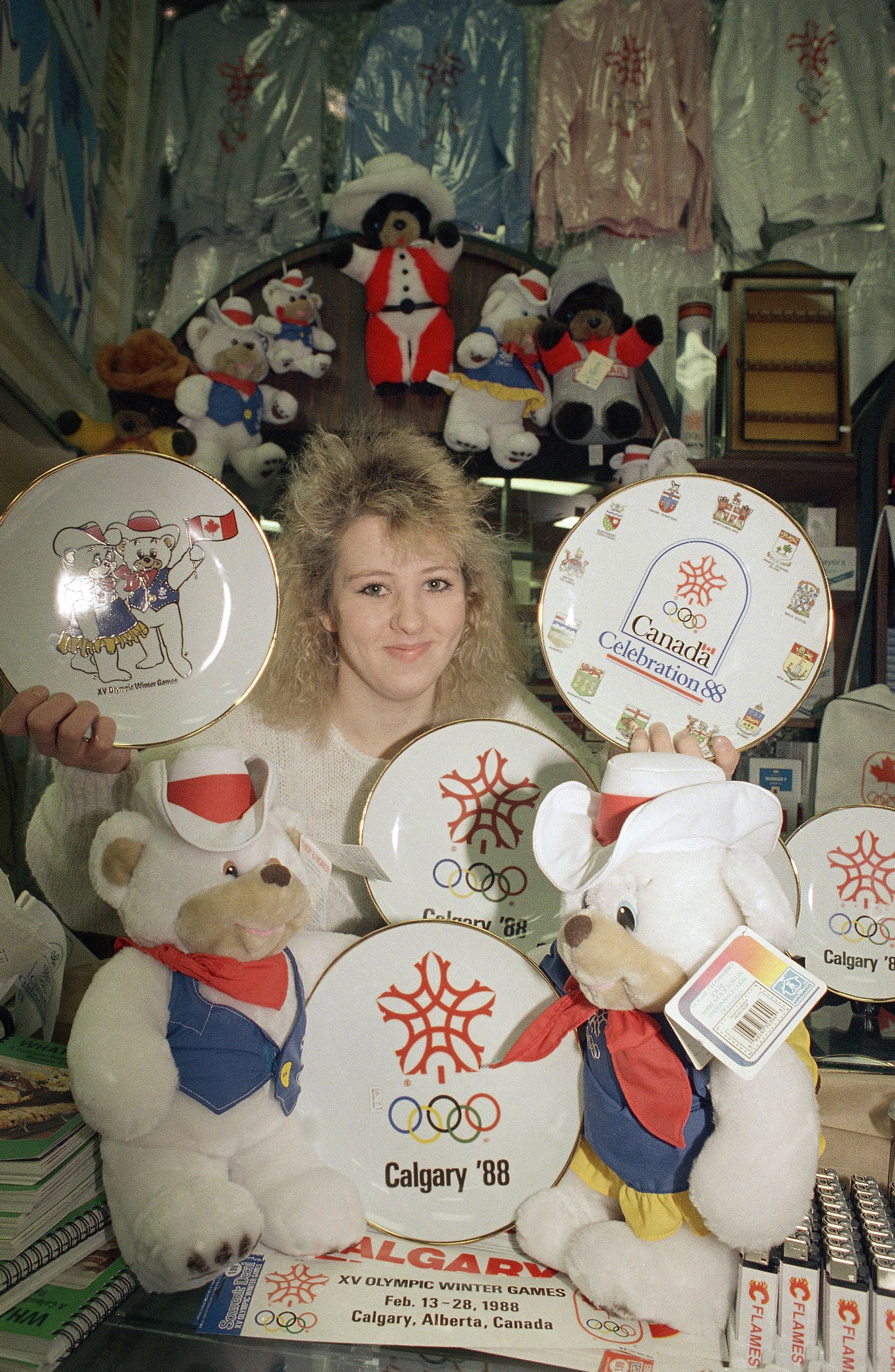  Allison McAbe is framed by all kinds of souvenirs in a Calgary, Alberta, shop on Feb. 7, 1988.  (AP Photo/Michel Lipchitz) 