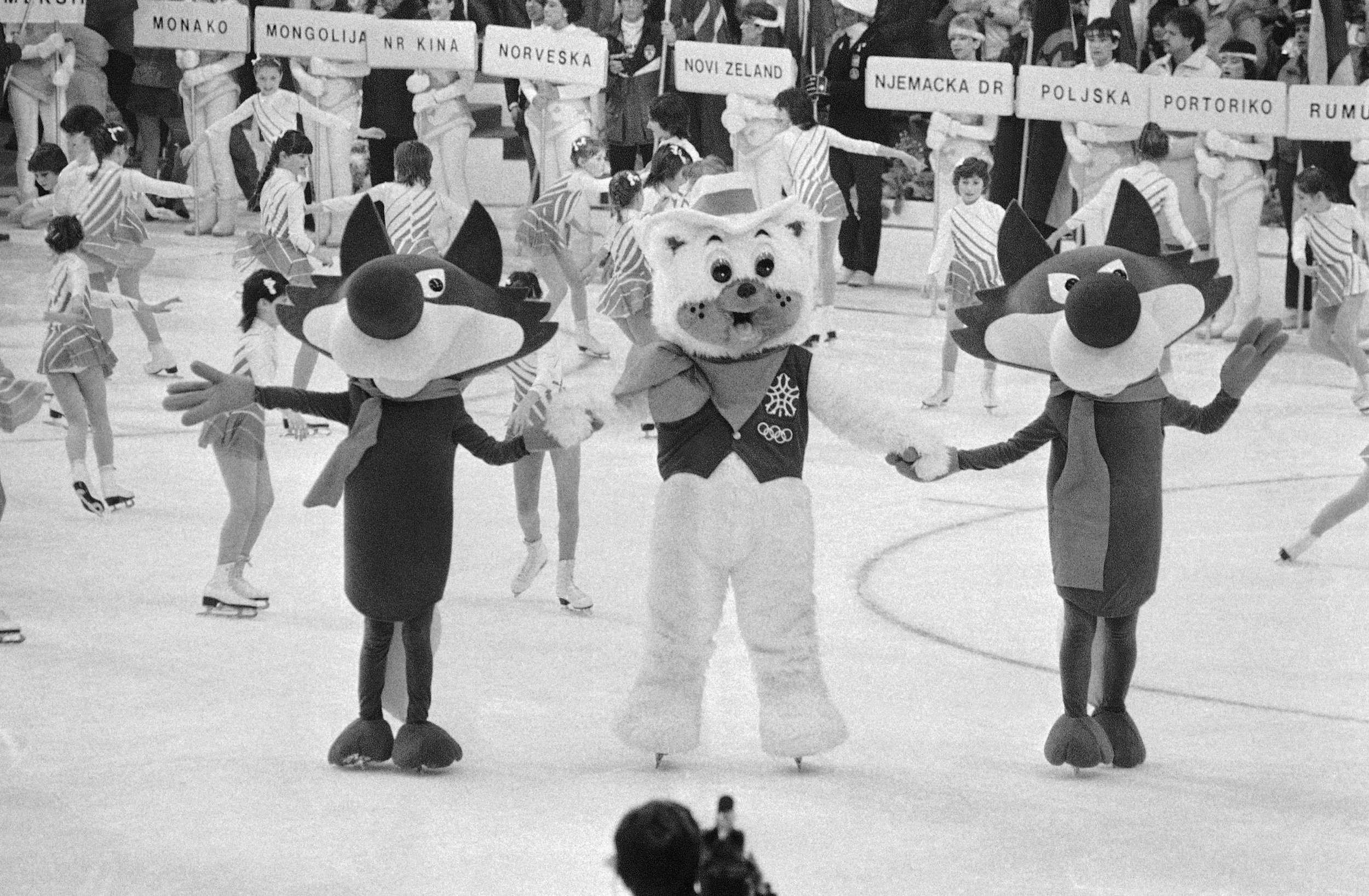  Vucko the wolf, the symbol for the XIV winter Olympic Games in Sarajevo's Yugoslavia, dances with Howdy the bear who will be the symbol for the next Winter Games, to be held on Calgary, Alberta, Feb. 19, 1984, at the closing ceremonies for the games