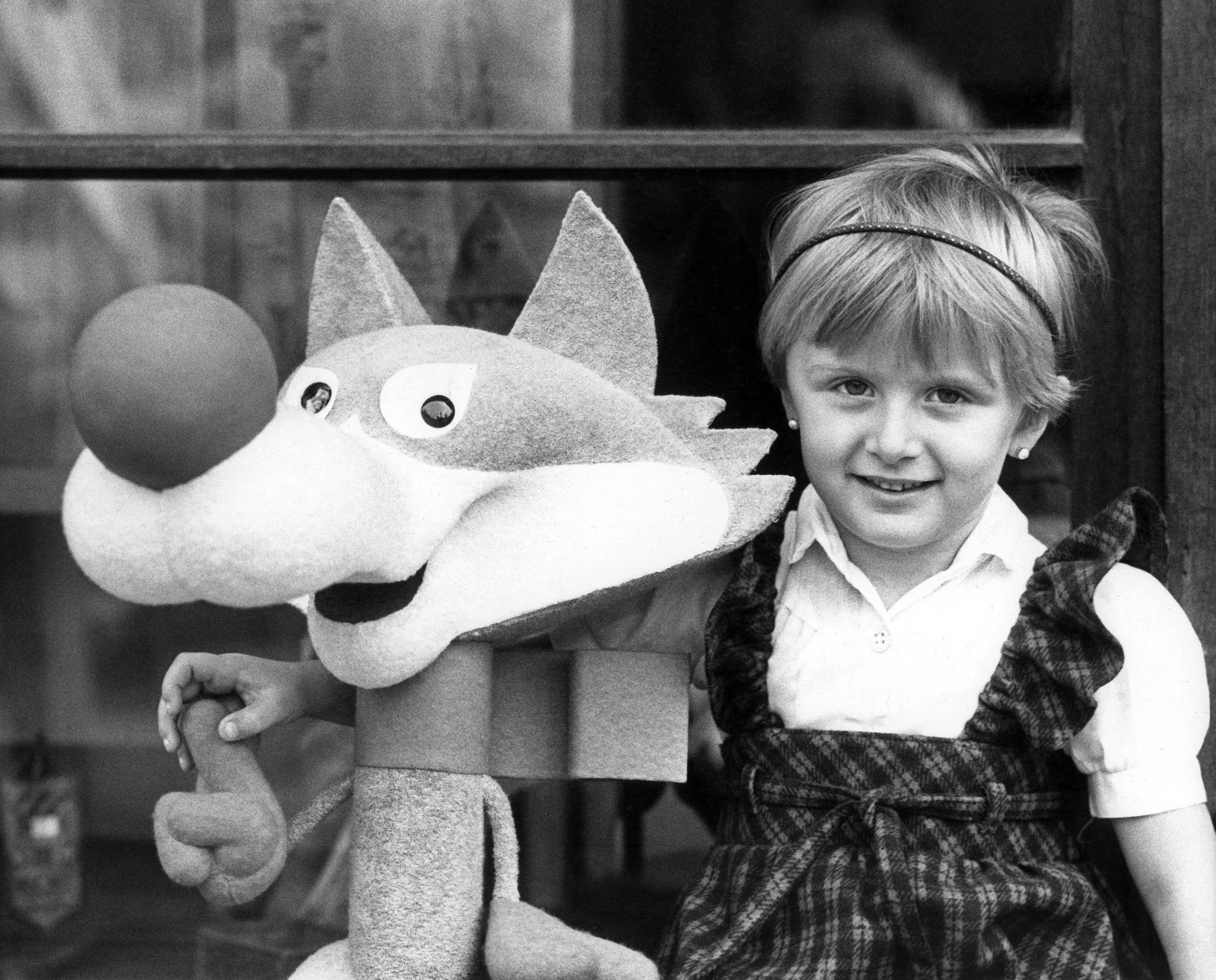  Amela Dizdar, 3, poses with a replica of the Winter Olympics mascot named Vucko in Sarajevo in 1984. The mascot was the creation of Joze Trobec, an academic painter from Kranj in Slovenia. (AP Photo/Bob Dear) 