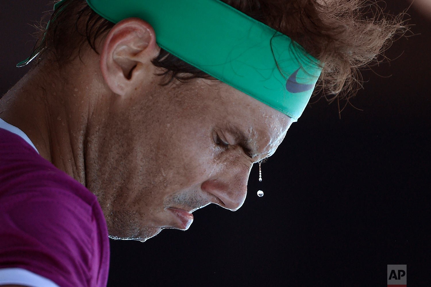 Sweat drops from the face of Rafael Nadal, of Spain, during a break in his second round match against Yannick Hanfmann, of Germany, at the Australian Open tennis championships in Melbourne, Australia, Wednesday, Jan. 19, 2022. (AP Photo/Andy Brownbi