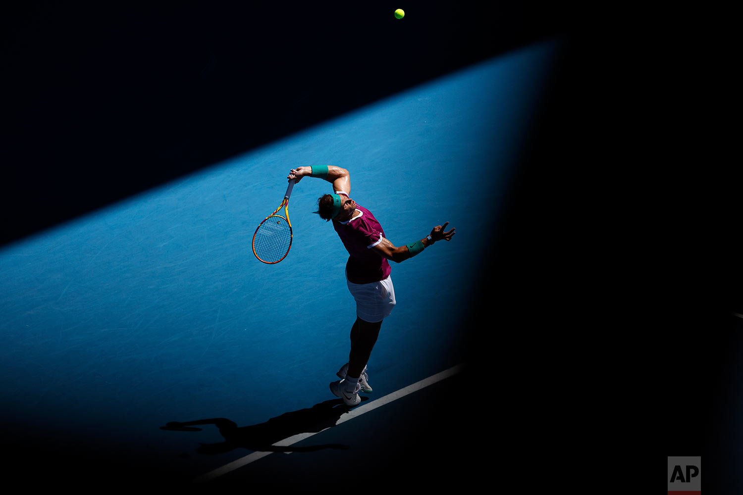  Rafael Nadal, of Spain, serves to Denis Shapovalov, of Canada, during their quarterfinal match at the Australian Open tennis championships in Melbourne, Australia, Tuesday, Jan. 25, 2022. (AP Photo/Hamish Blair) 