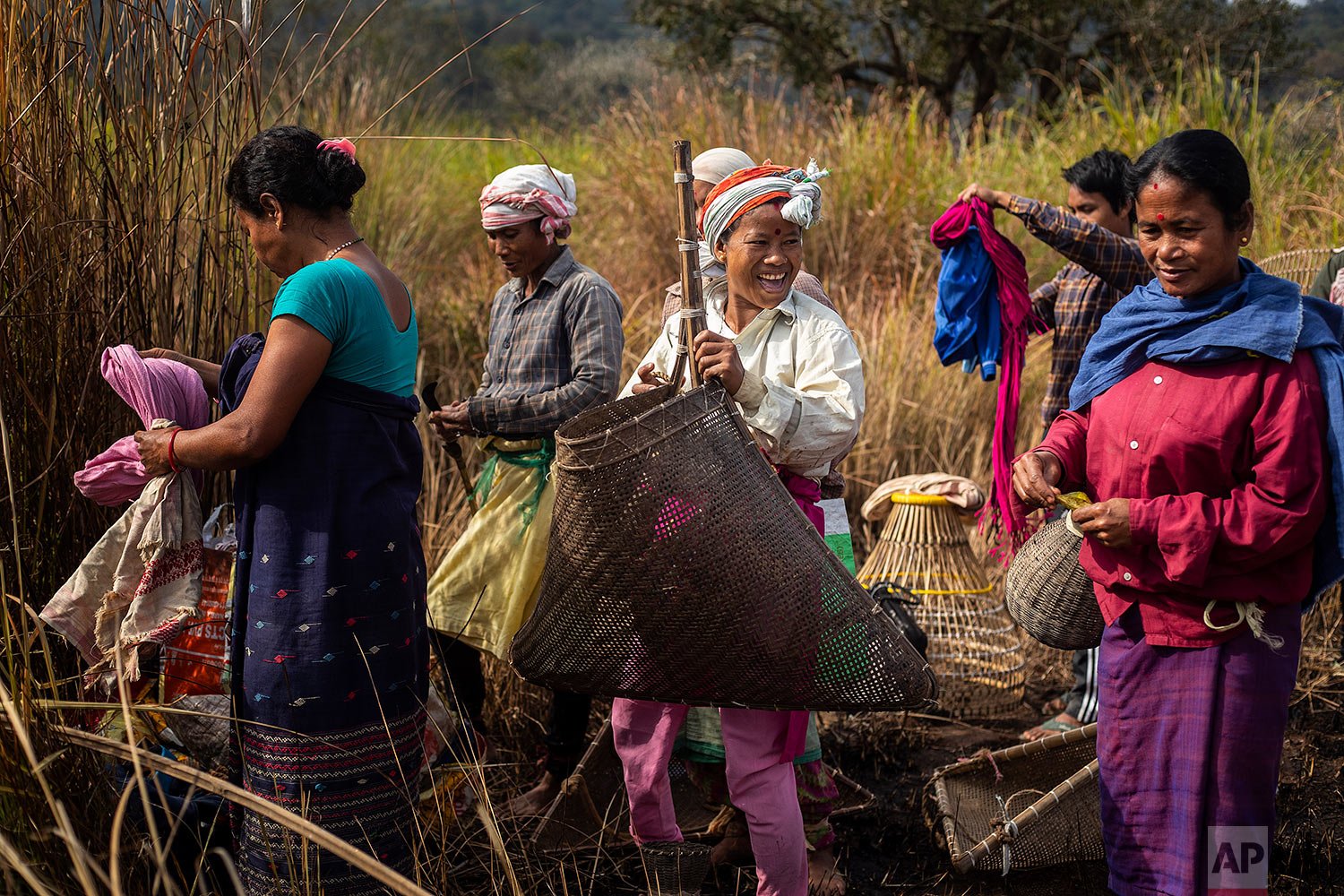  Tribal women arrive with their fishing tools to participate in community fishing as part of Bhogali Bihu celebrations, marking the end of the harvest season in Panbari village, some 50 kilometers (31 miles) east of Gauhati, India, Thursday, Jan. 13,