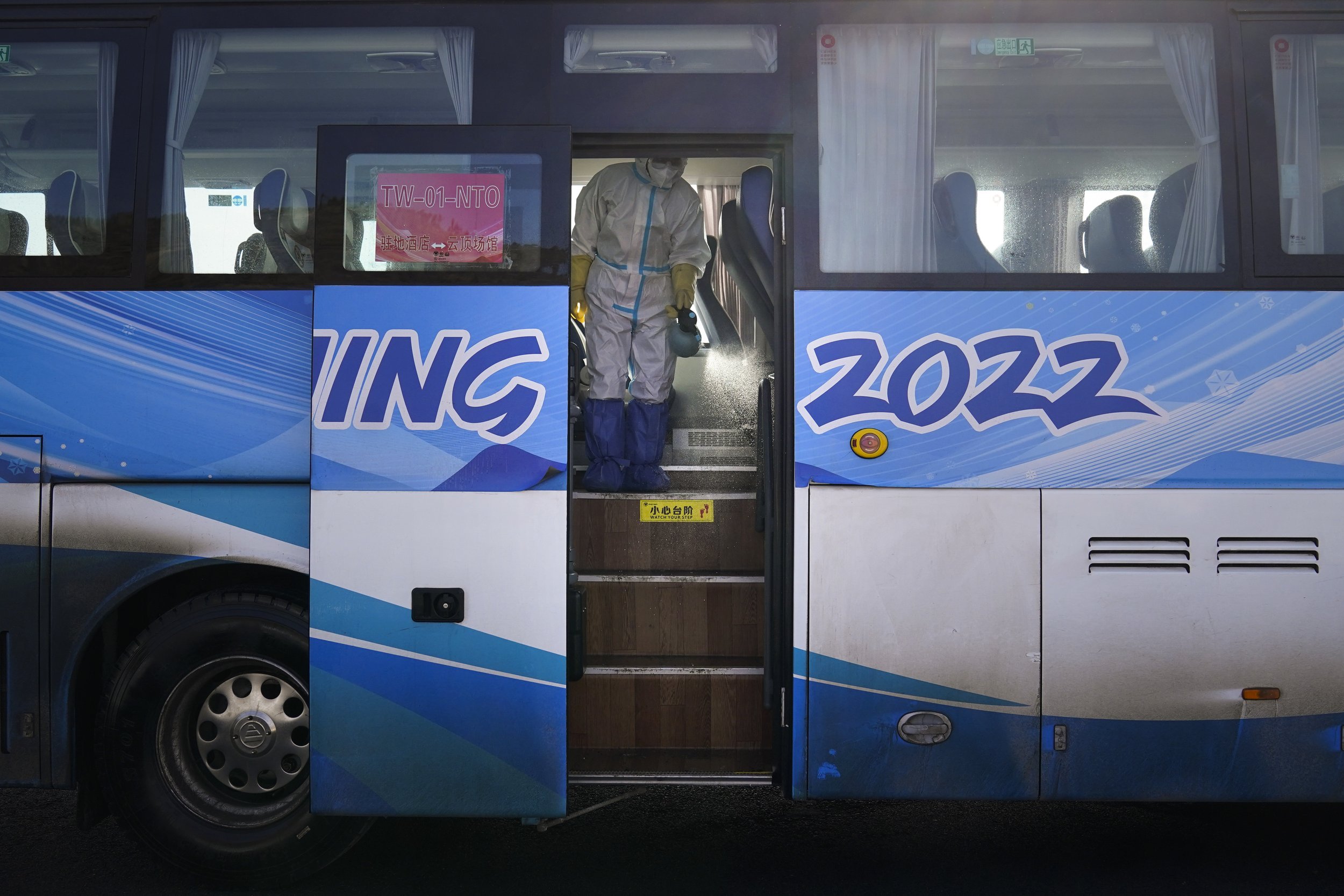  A worker in protective gear disinfects an Olympic shuttle bus ahead of the 2022 Winter Olympics, Sunday, Jan. 30, 2022, in Zhangjiakou, China. (AP Photo/Jae C. Hong) 