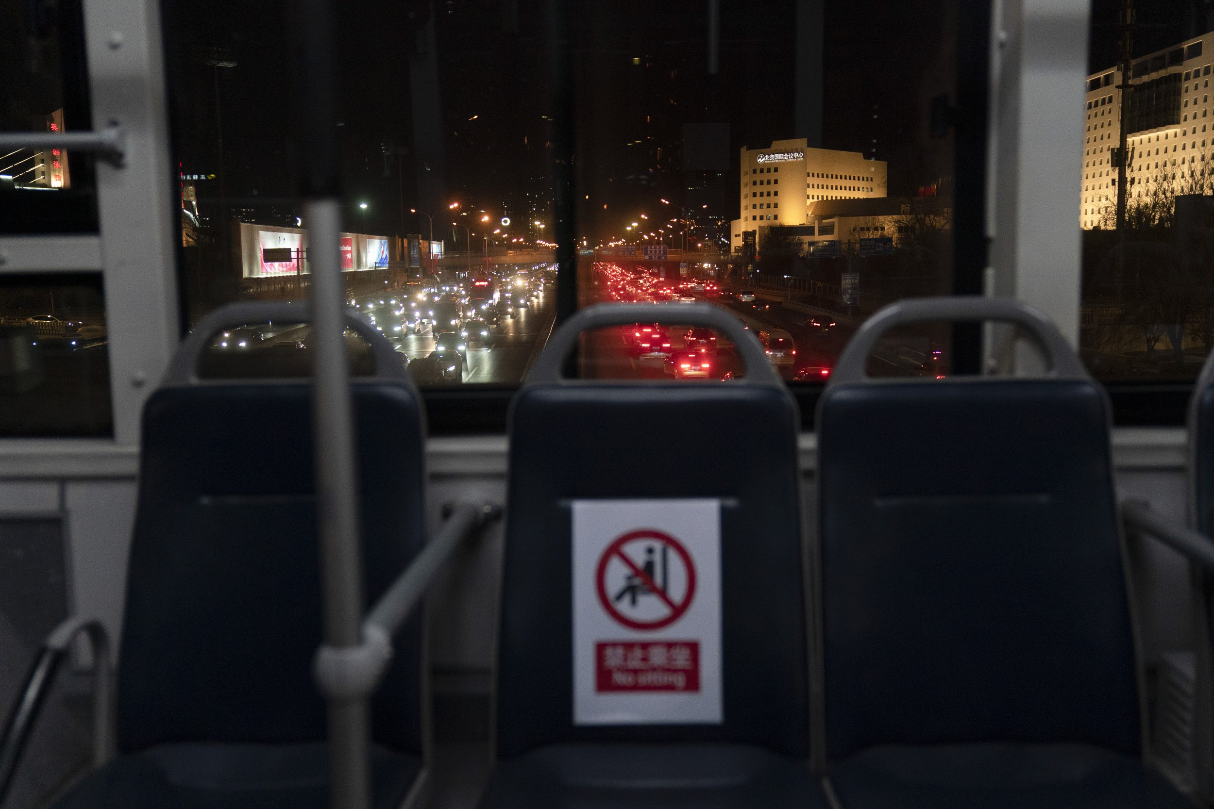  Evening rush hour traffic is seen through the window of an Olympic shuttle bus ahead of the 2022 Winter Olympics, Tuesday, Jan. 25, 2022, in Beijing. (AP Photo/Jae C. Hong) 